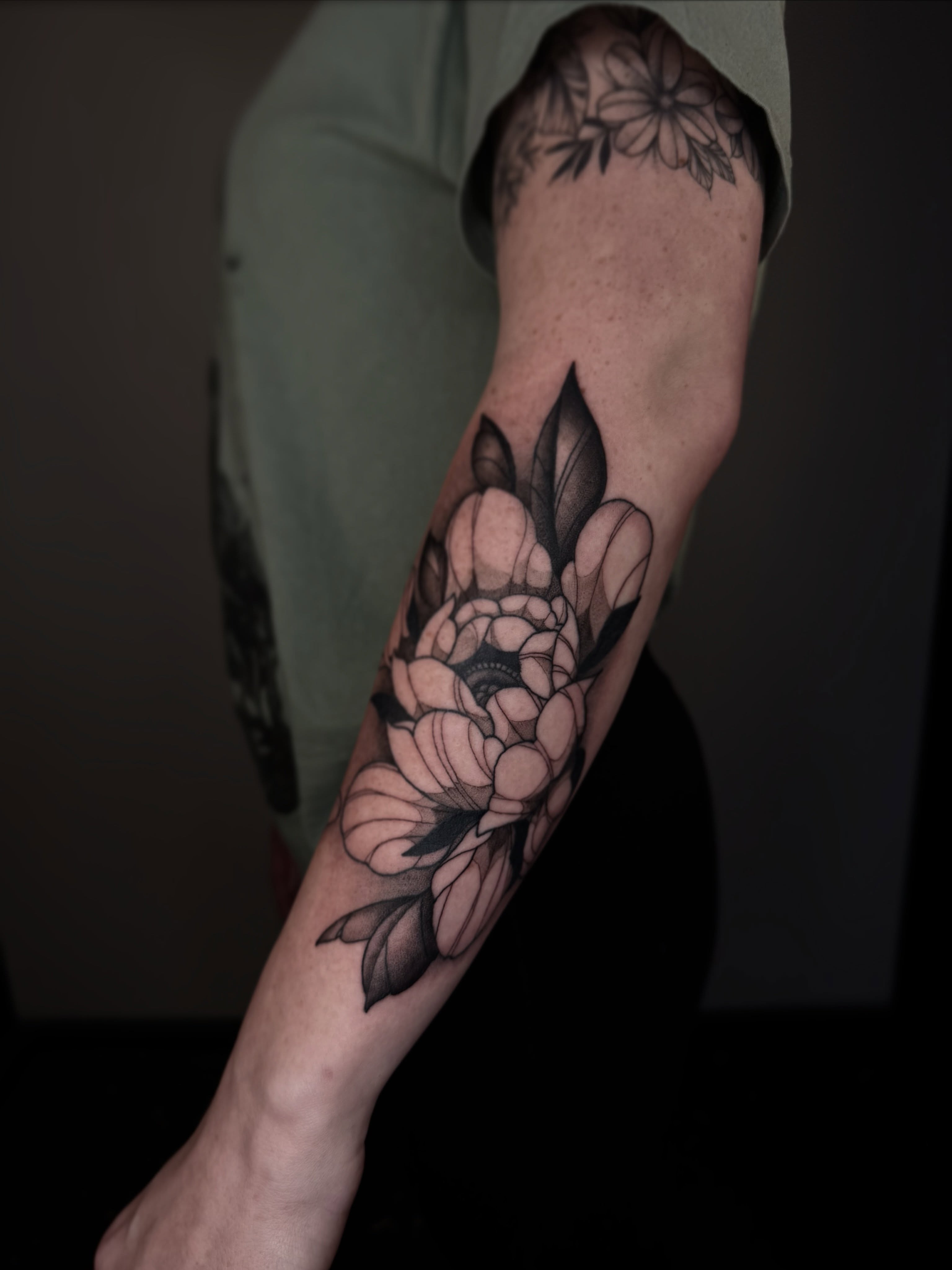 Peony black and grey tattoo on the forearm by Brandon Shelby