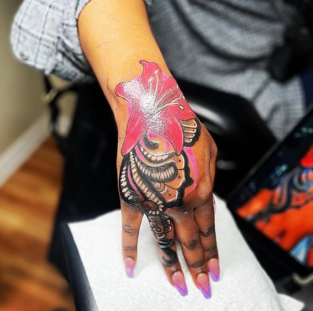 Flower and ribcage neo-traditional tattoo on the hand by Inkby_larry