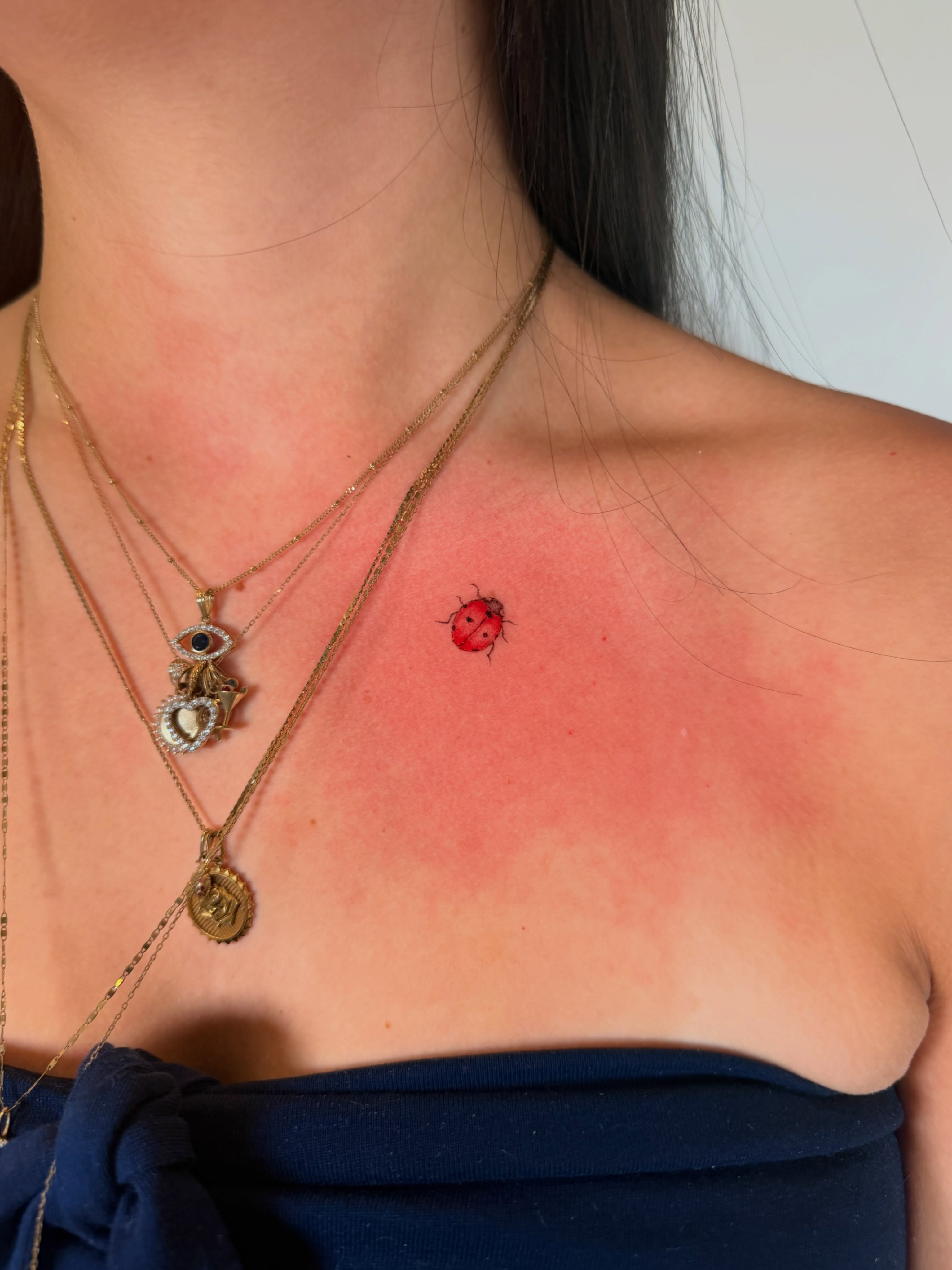 Ladybug realism tattoo on the chest by Seattle Fine Line Tattoo