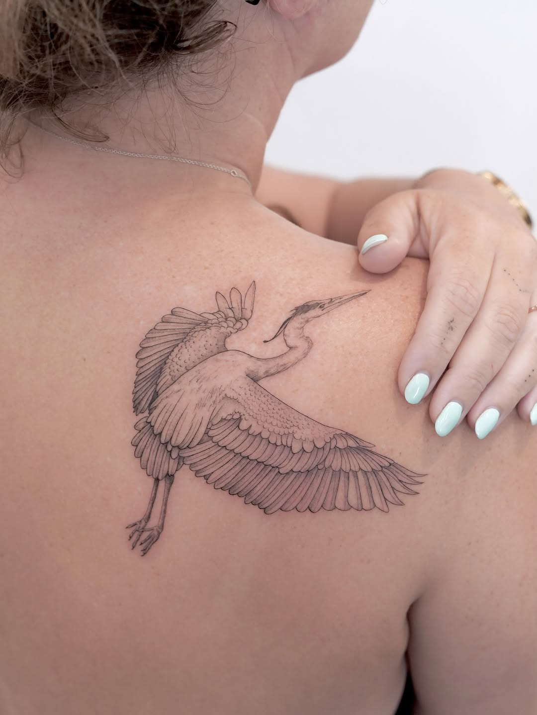 Heron in flight fine line tattoo on the shoulder by Julia