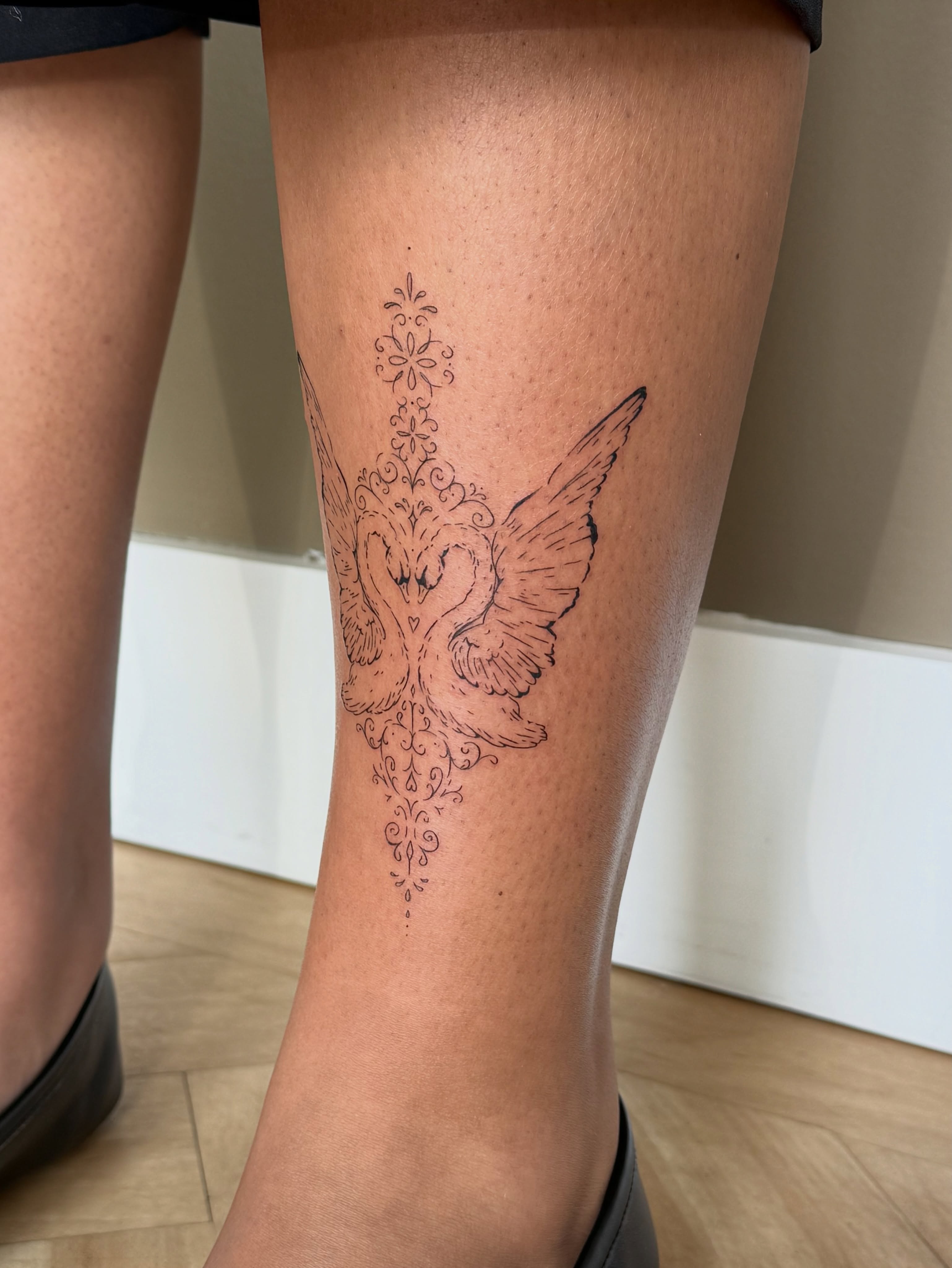 Dove with floral ornamentation ornamental tattoo on the leg by Fine Line Tattoos