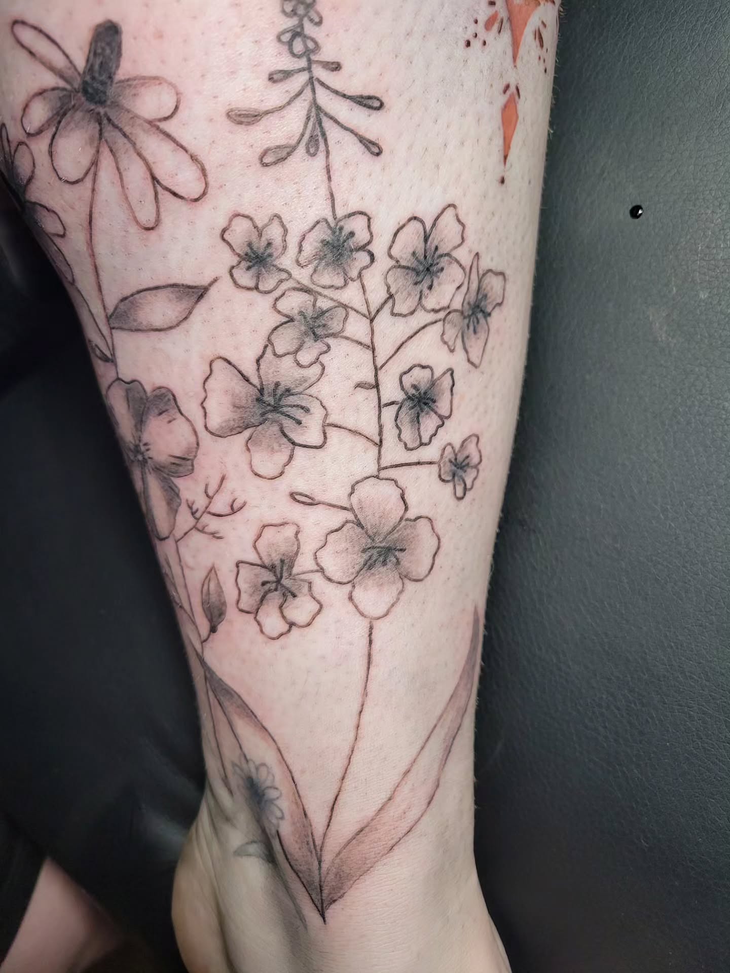 Floral arrangement black and grey tattoo on the forearm by Bee