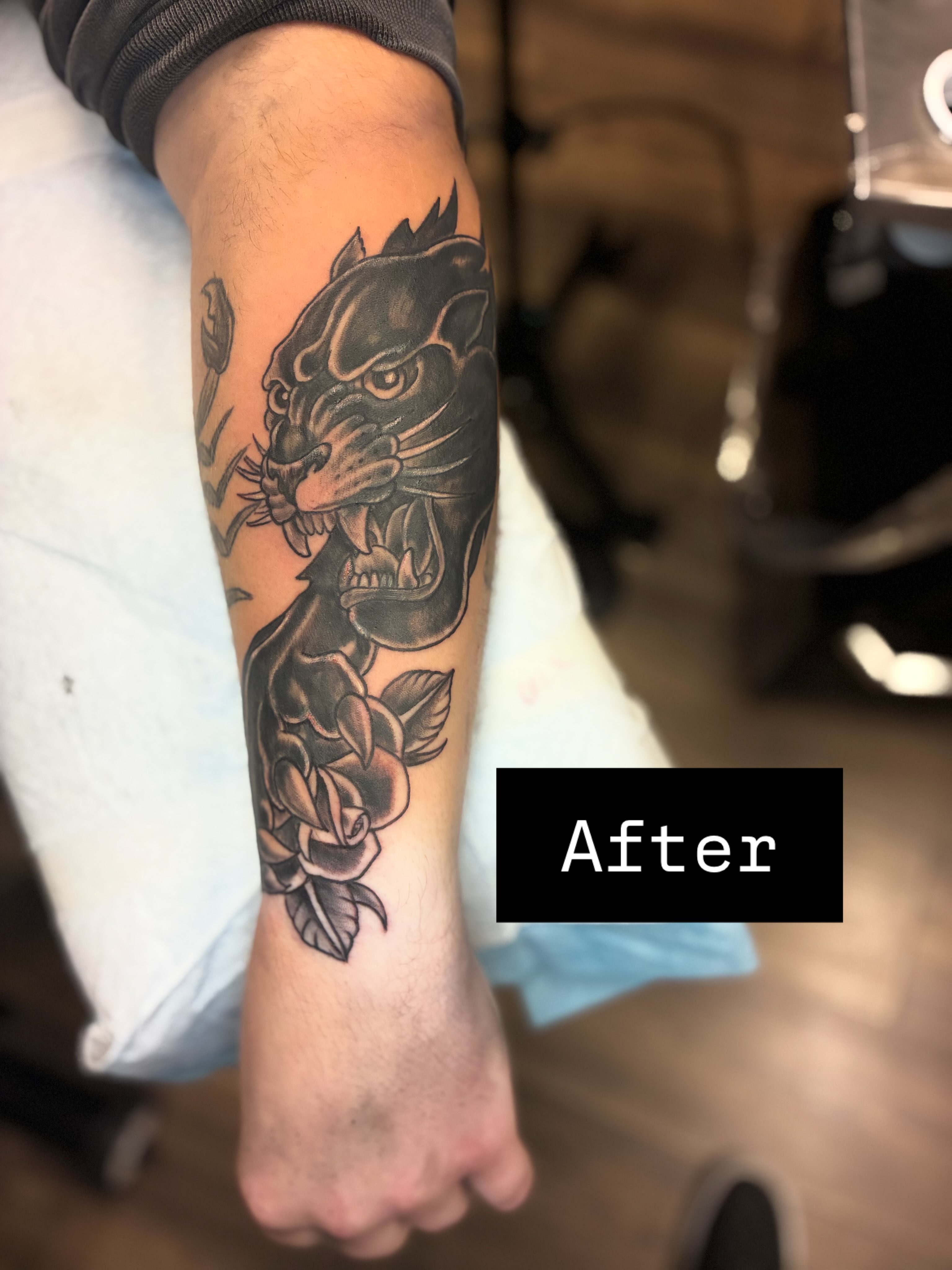 Panther and rose realism tattoo on the forearm by Kevin Strong
