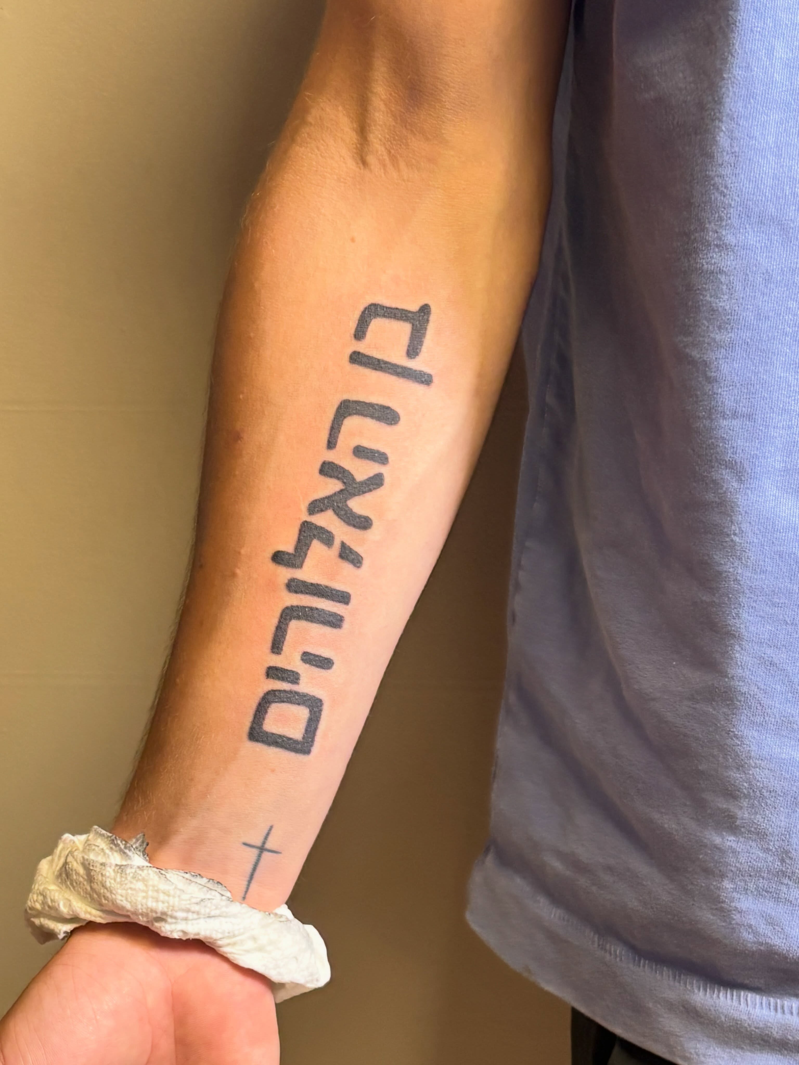 Hebrew phrase lettering script tattoo on the forearm by Natalie Jade Shupe