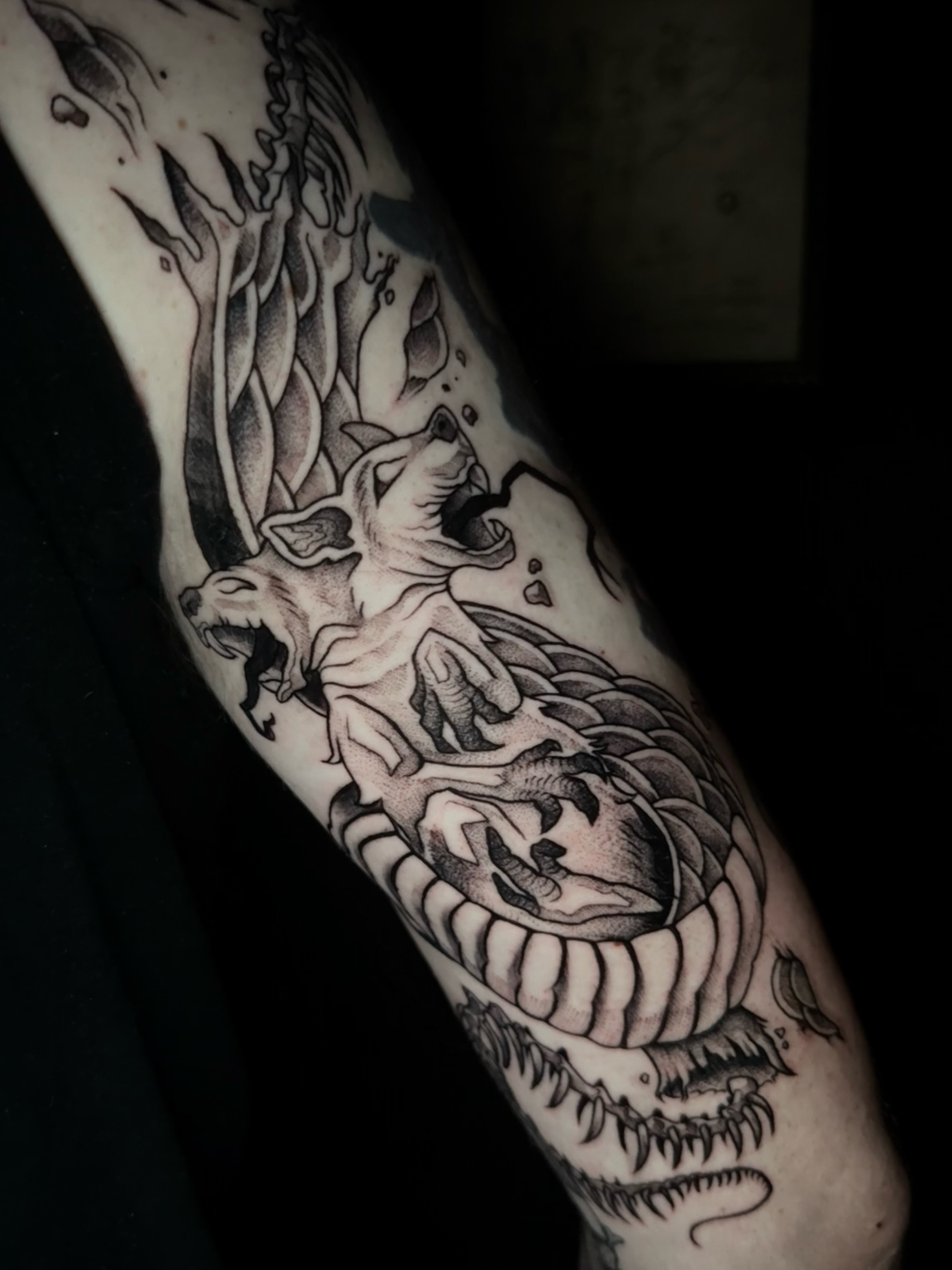 Wolf and flames dark realism tattoo on the forearm by Exploitedtattoos