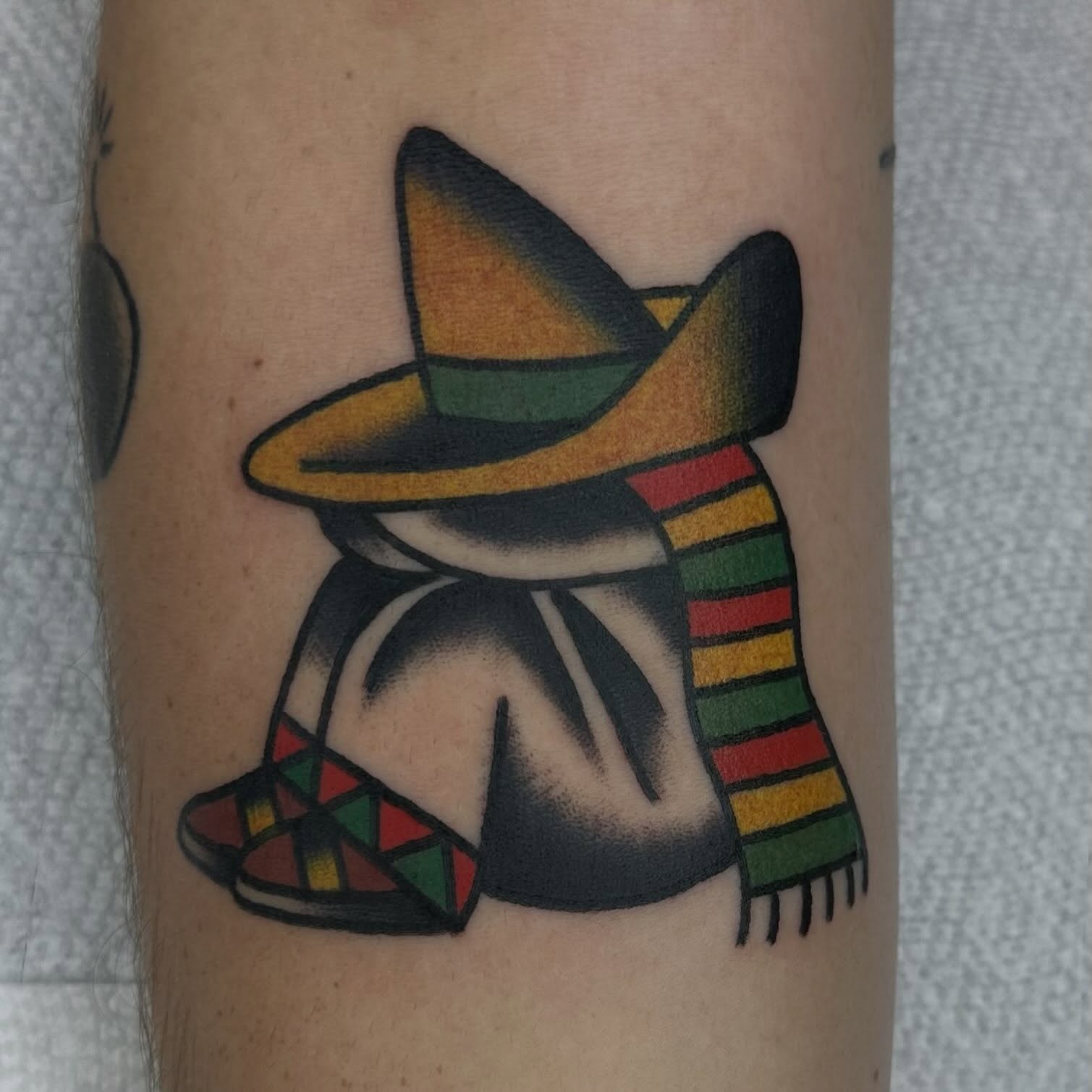 Sombrero-wearing figure American traditional tattoo on the forearm by Keon Ostby, Tempe, Arizona