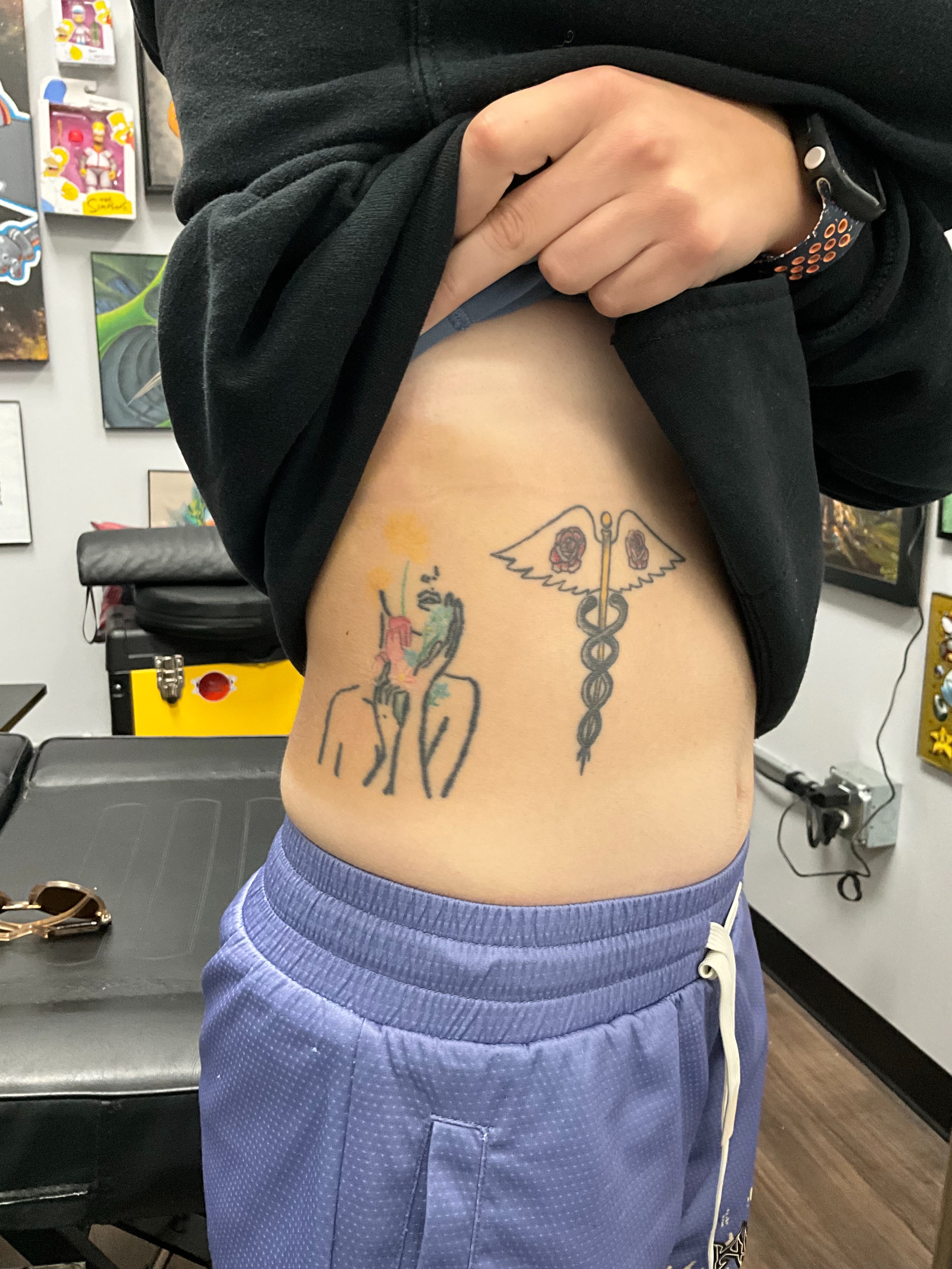 Caduceus and unicorn American traditional tattoo on the torso by Thomas Harris