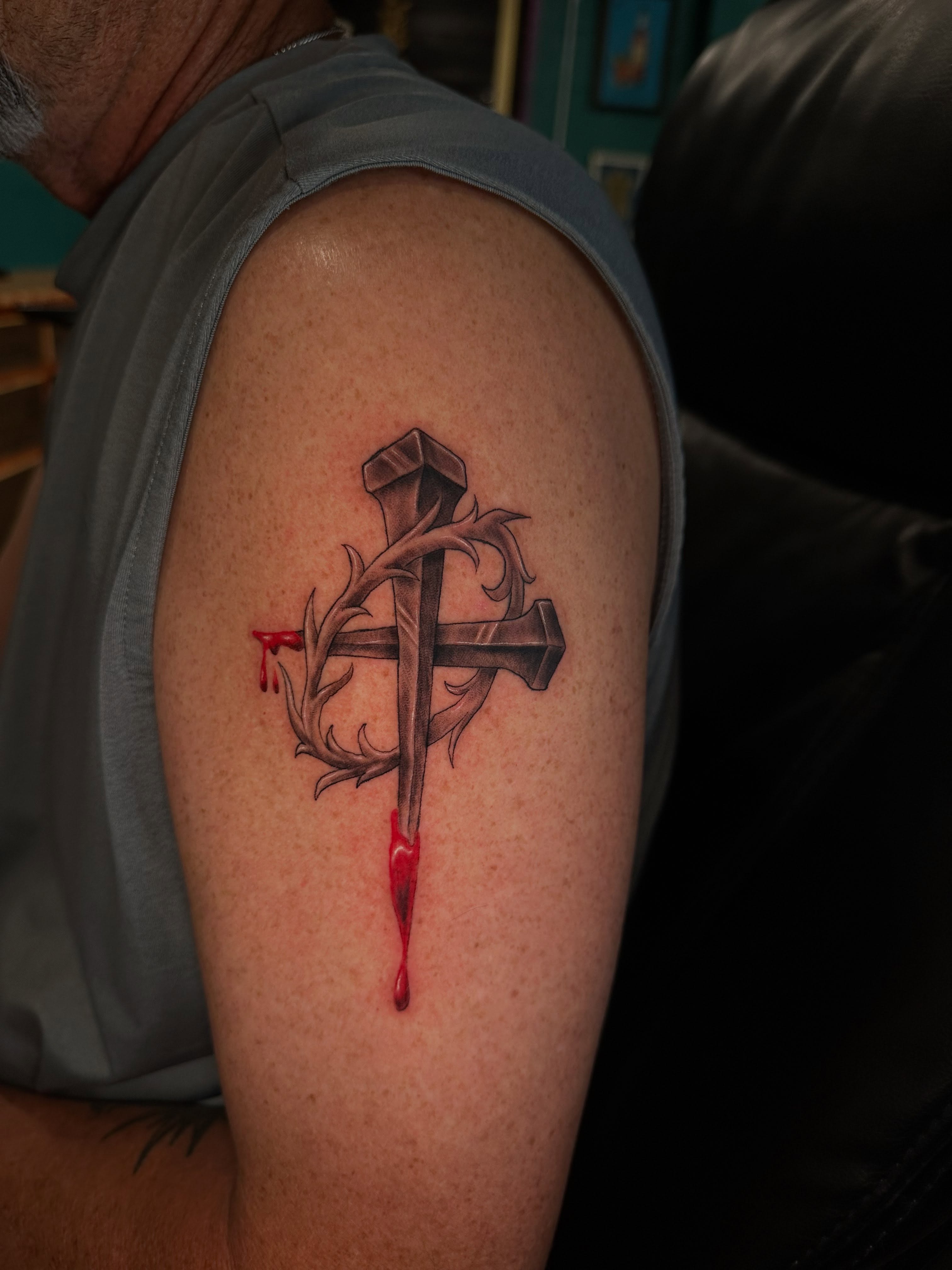 Cross with nails and thorns realism tattoo on the shoulder by Mario Flores Tattoo