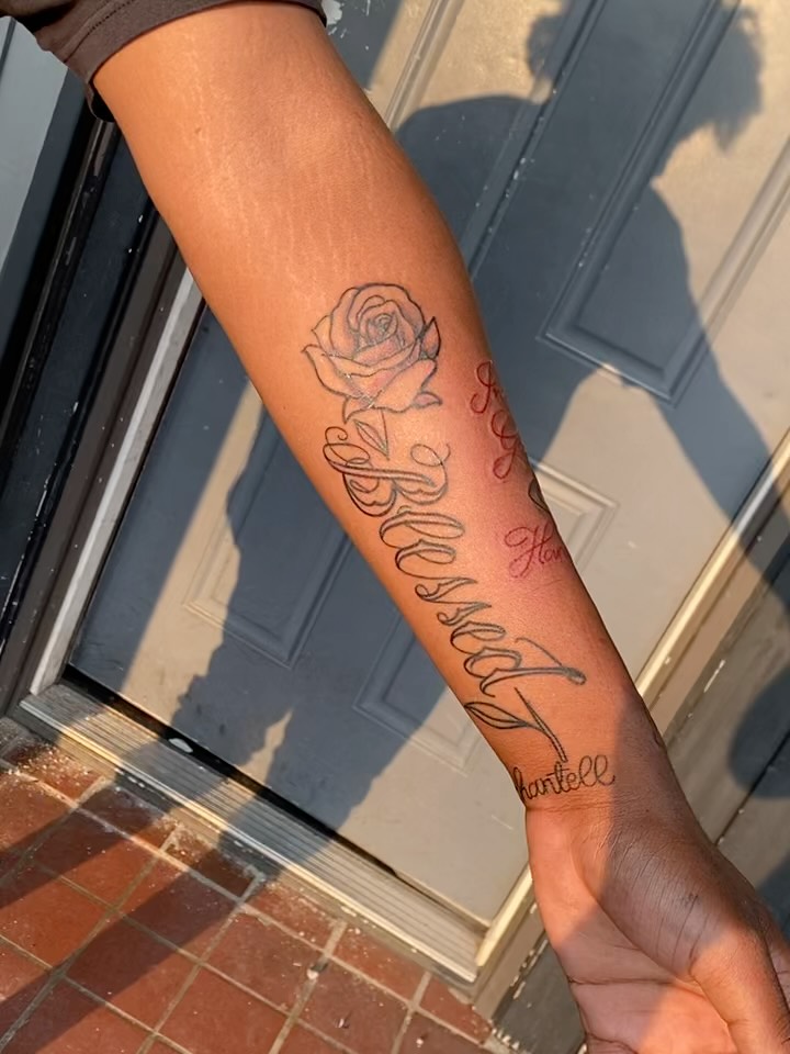 Rose and cursive text black and grey tattoo on the forearm by Mariš¤, Chicago, Illinois