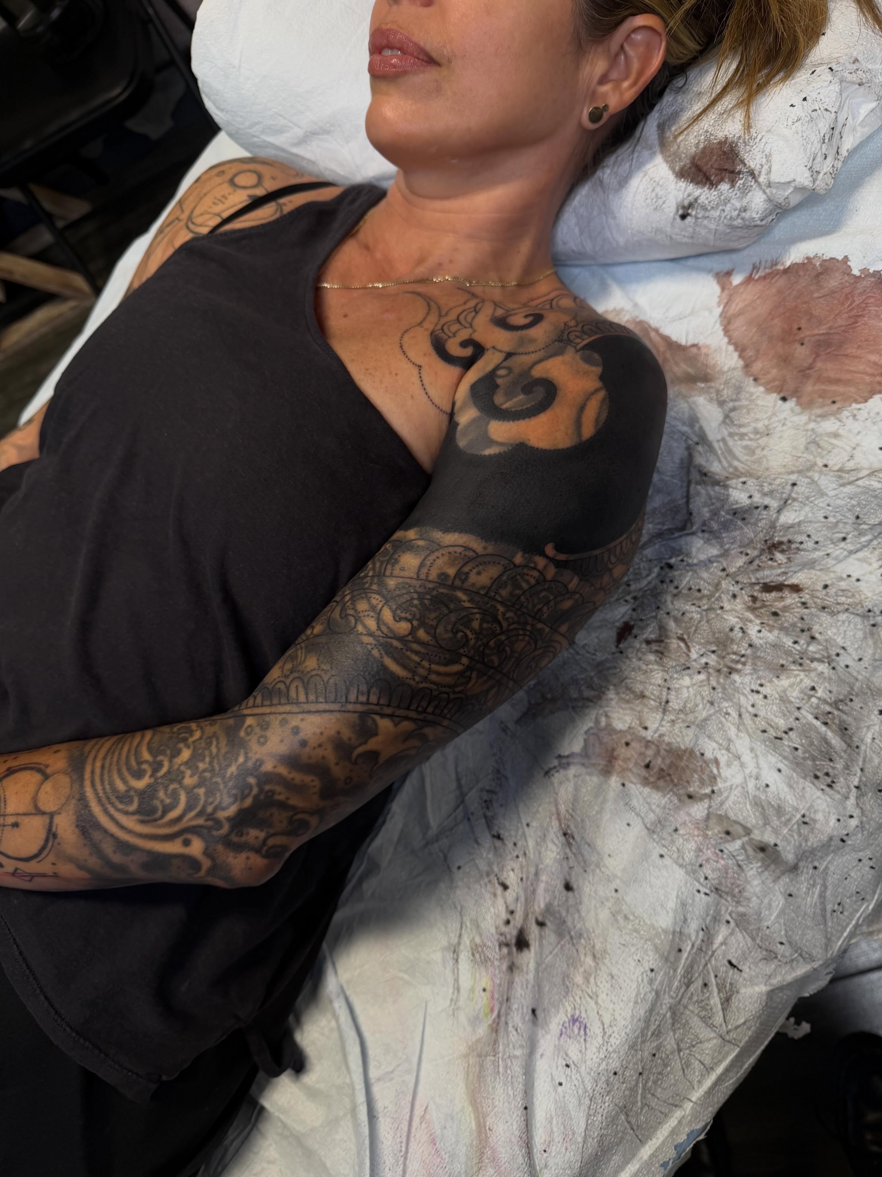 Abstract design black and grey tattoo on the upper arm by <