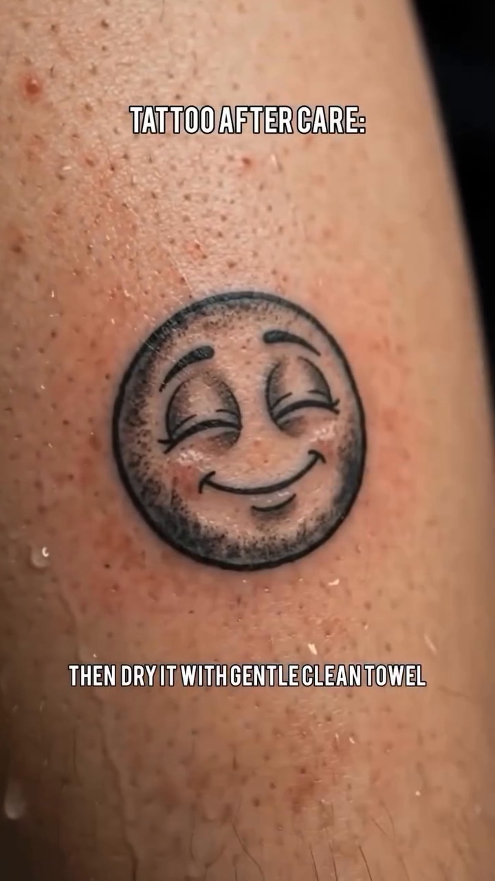 Emoji face realism tattoo on the upper arm by Jose Onasis Disla, New York, New York