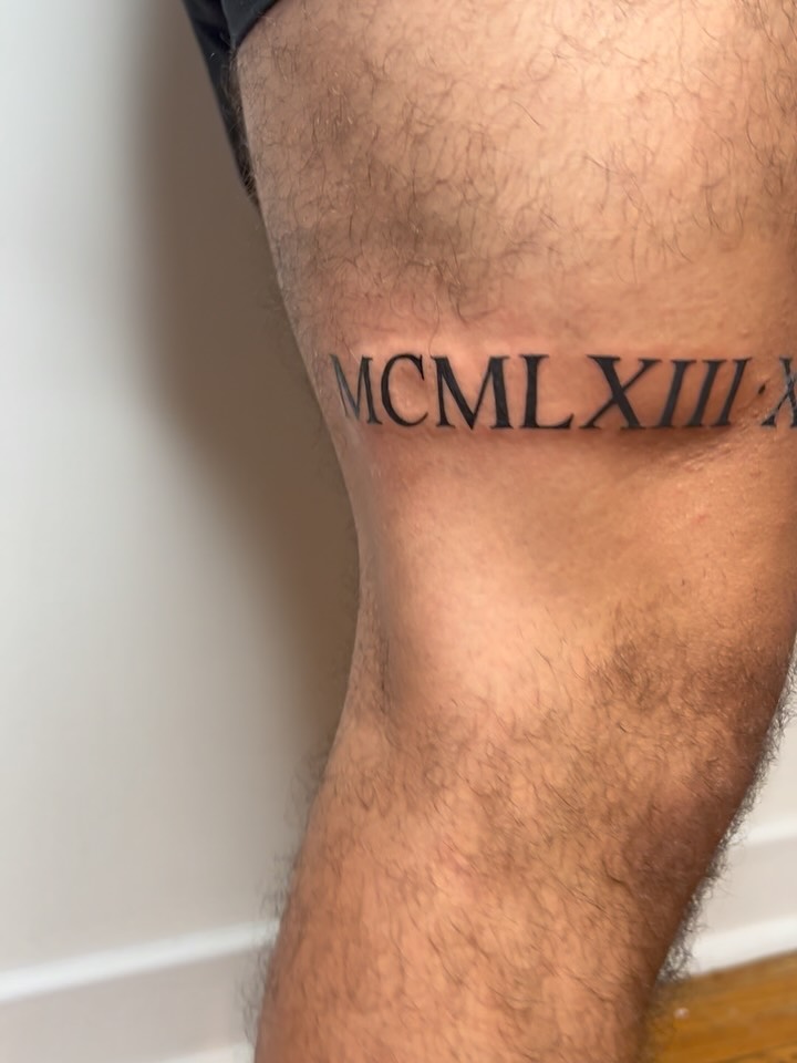 Roman numerals lettering script tattoo on the thigh by Juan pablo, Toronto, Ontario
