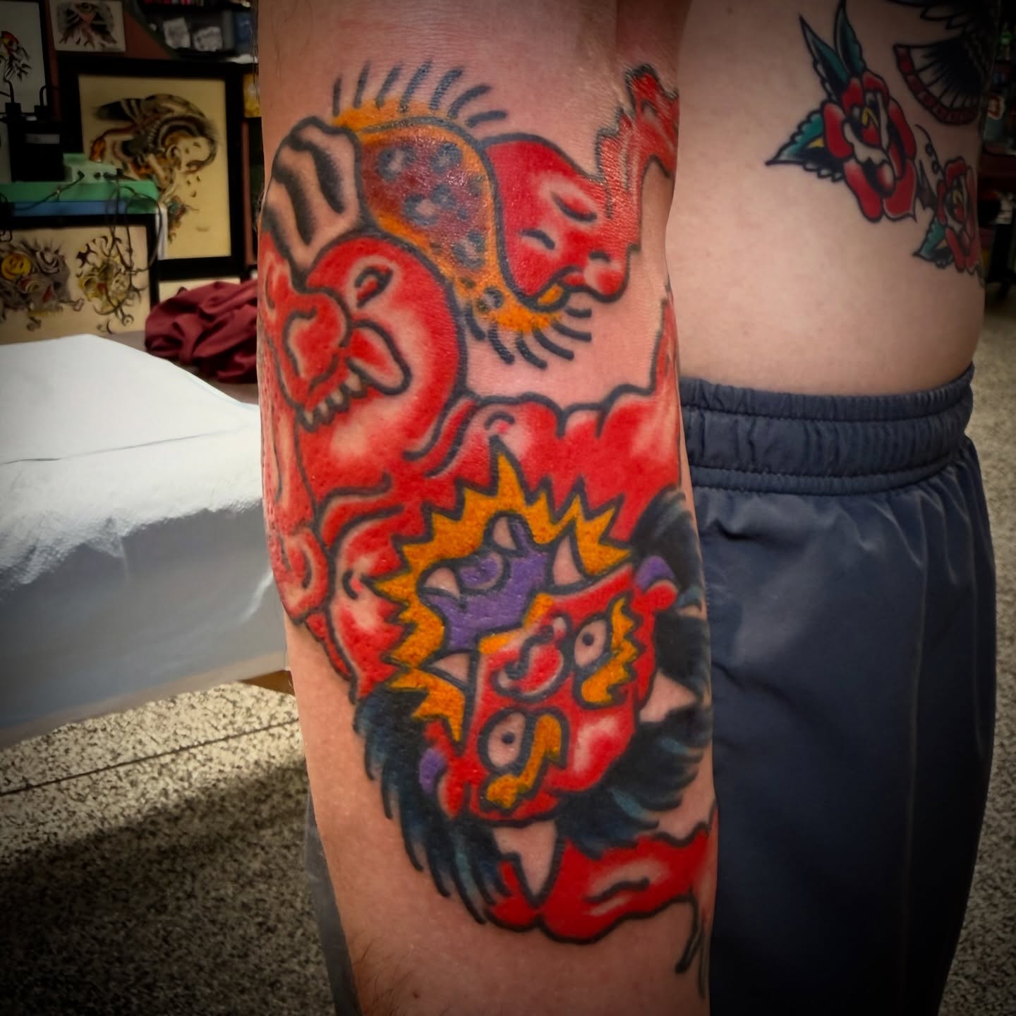 Lion heads American traditional tattoo on the forearm by Chuck Paprocki, Nashville, Tennessee