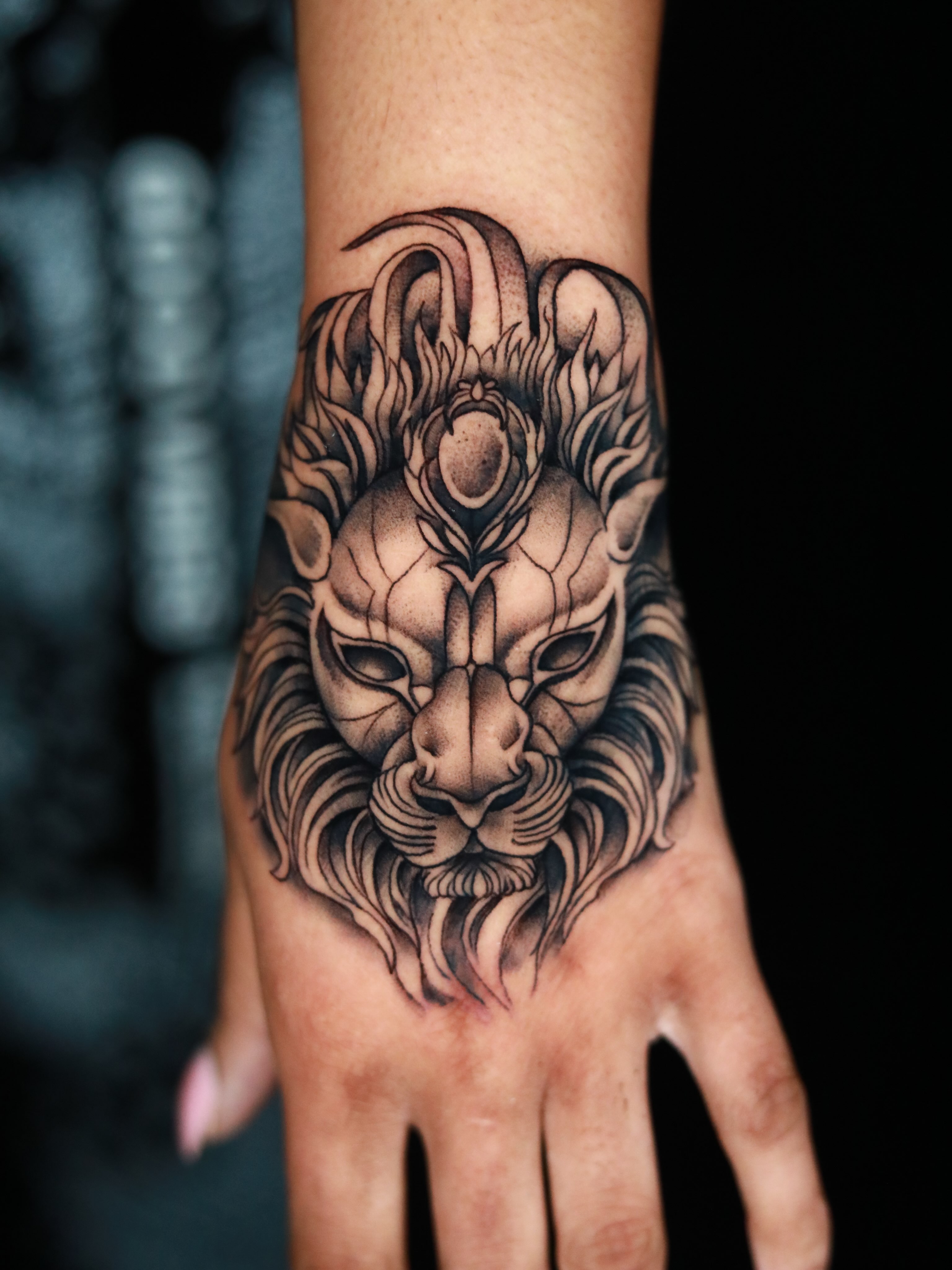 Lion head black and grey tattoo on the hand by Cuda
