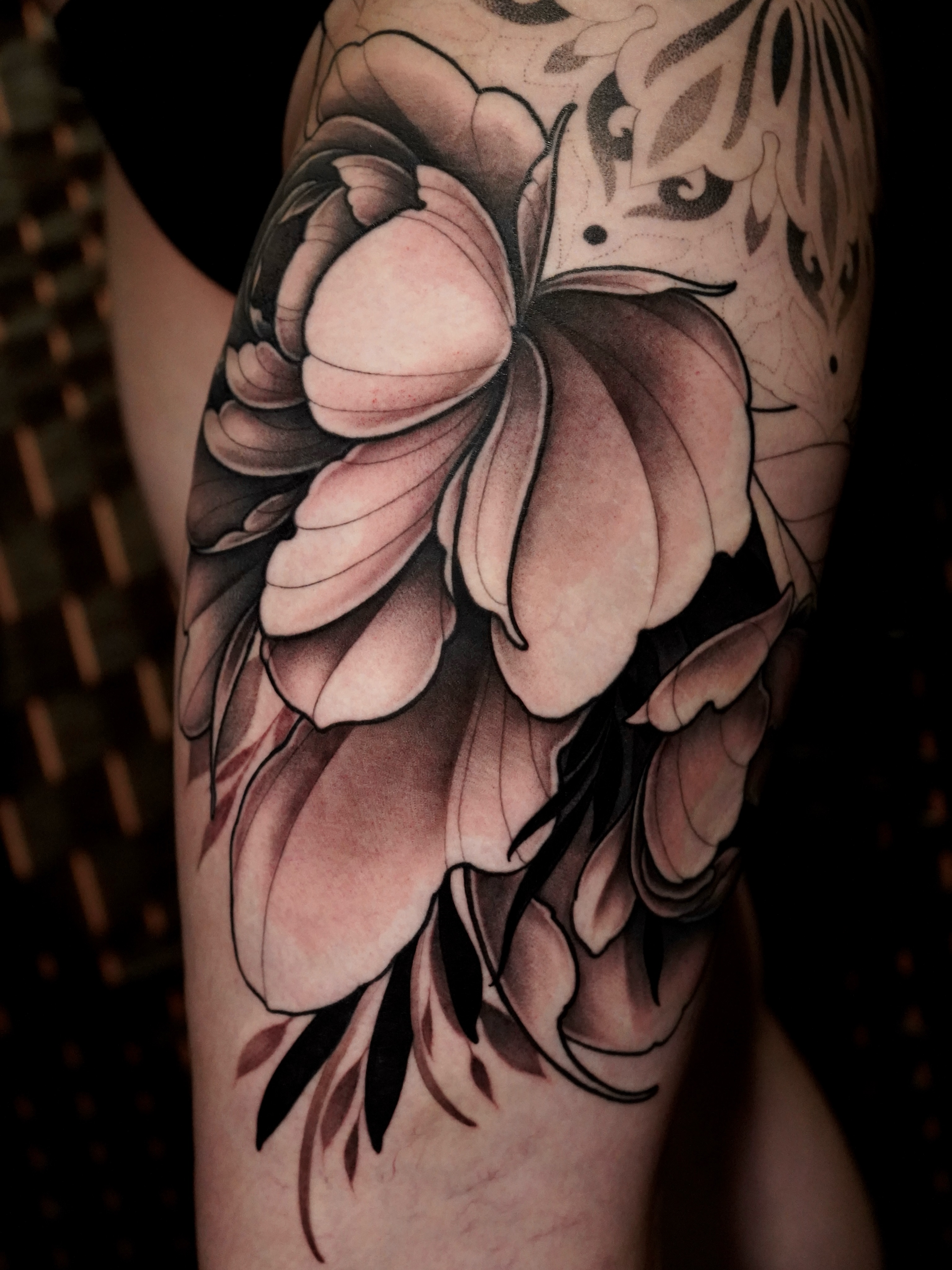 Flower black and grey tattoo on the forearm by Haley Corinne