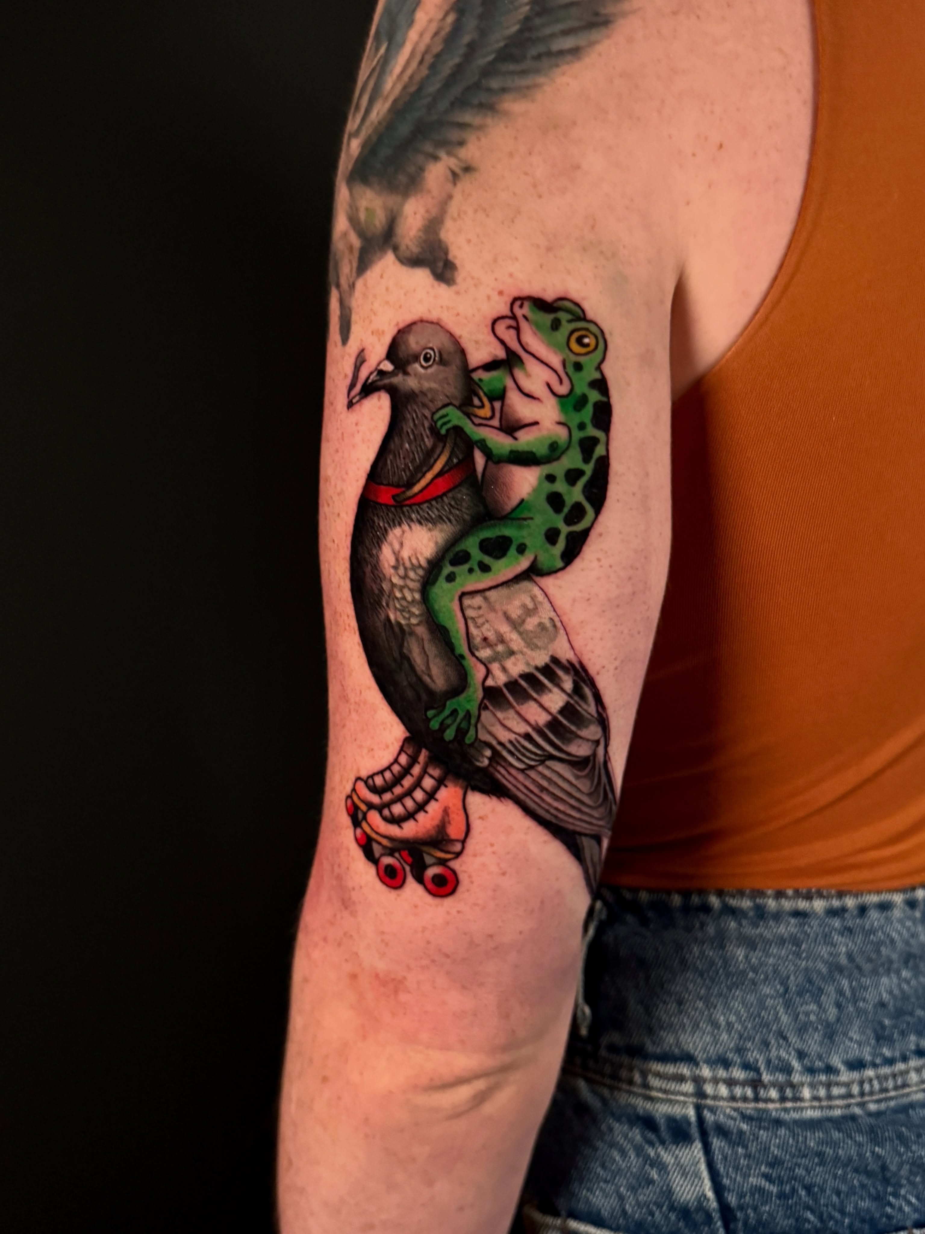 Frog riding pigeon American traditional tattoo on the forearm by Dallas Tattoo Artist