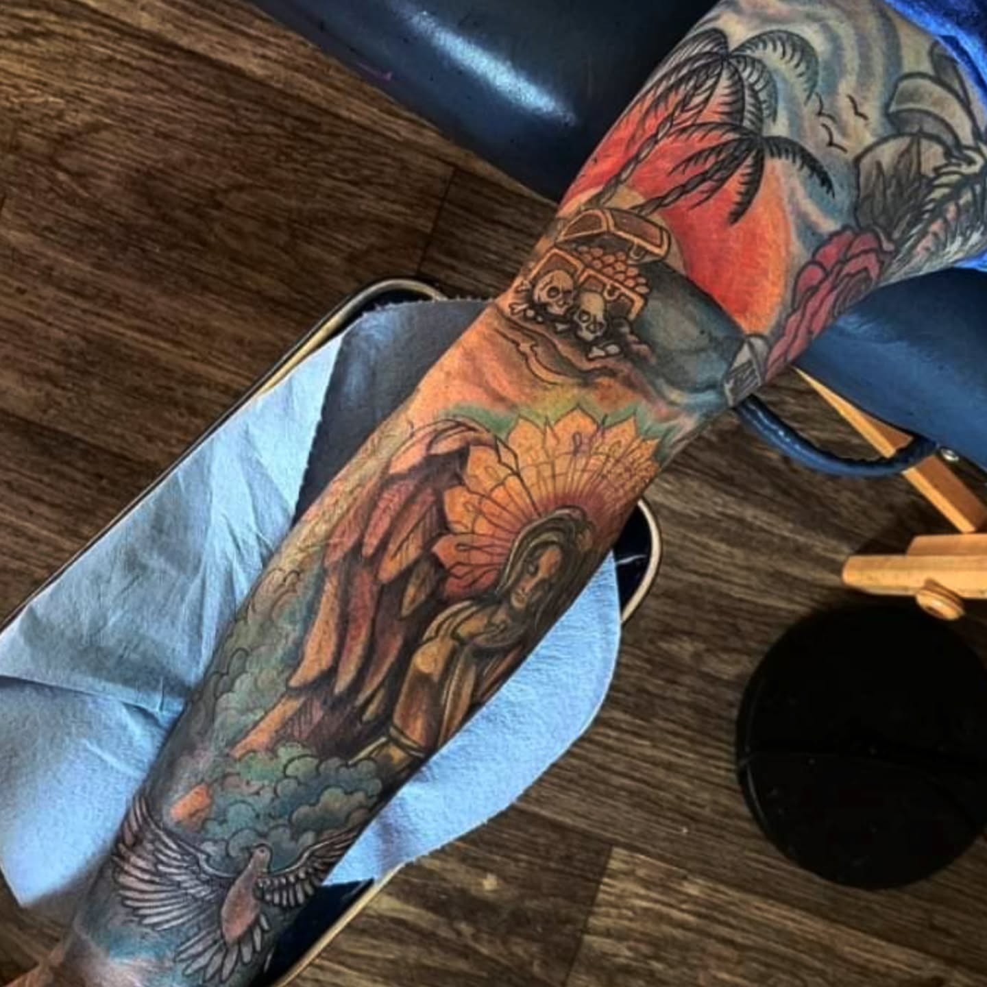 Buddha statue American traditional tattoo on the forearm by Shane Watkins