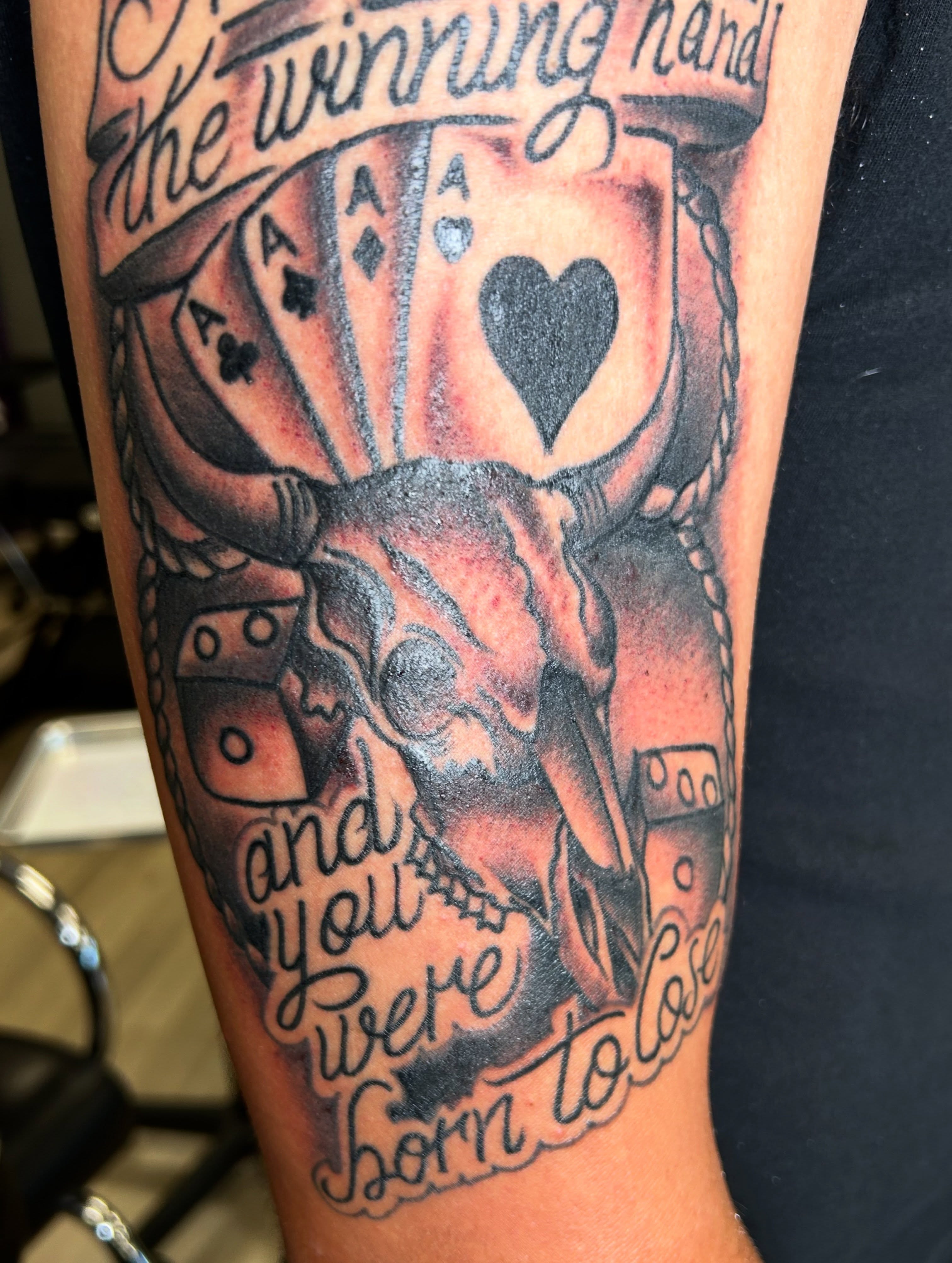 Bull skull and playing cards American traditional tattoo on the forearm by Erik Sacony