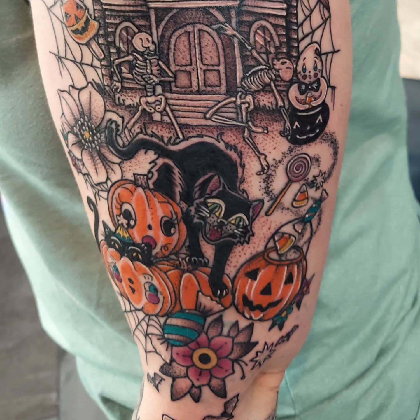 Halloween-themed tattoo American traditional tattoo on the forearm by Kari Rhoades, Marion, Iowa