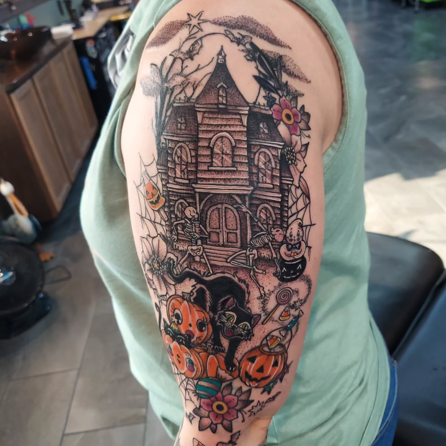 Haunted house American traditional tattoo on the forearm by Kari Rhoades, Marion, Iowa