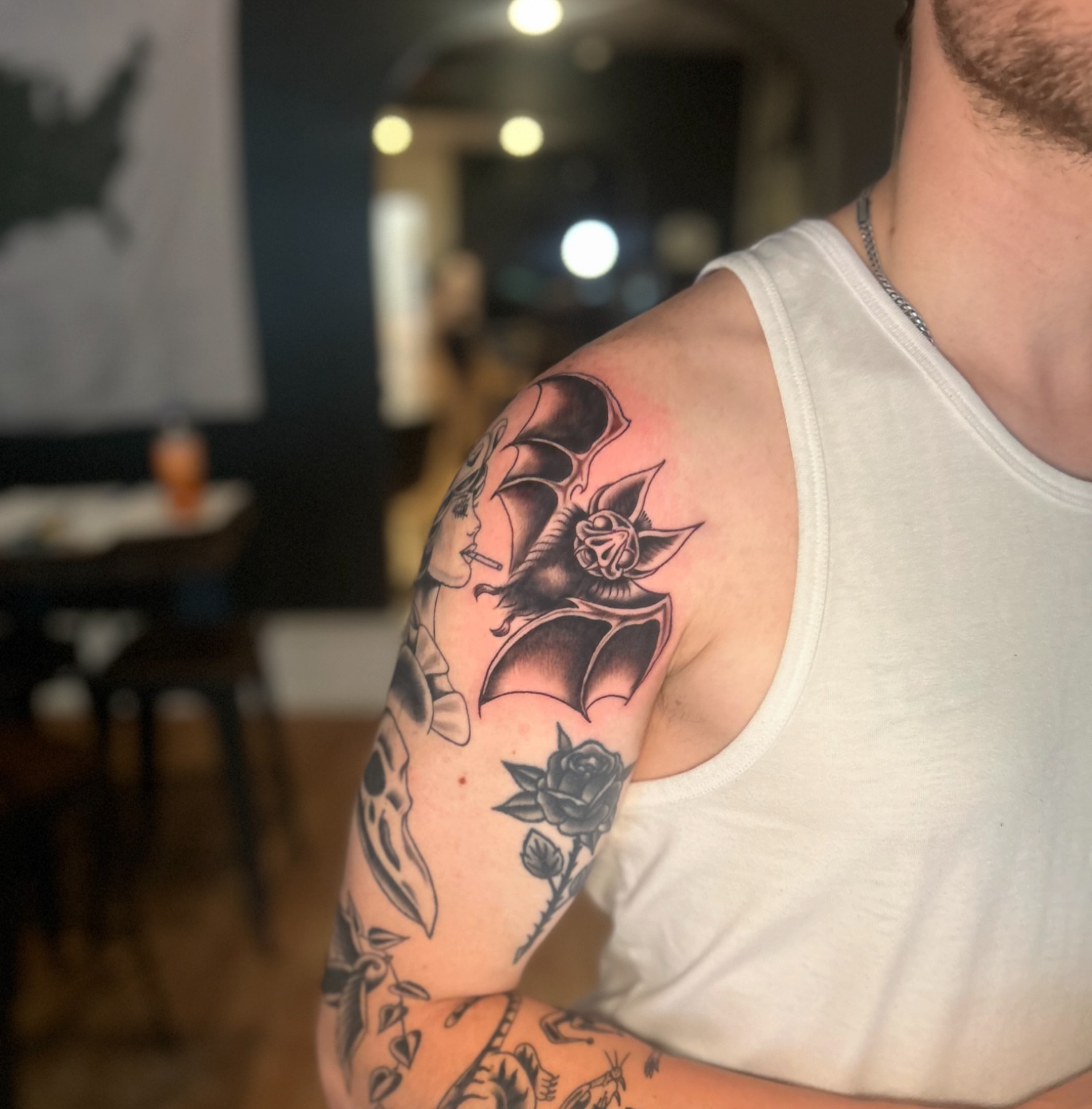 Bat and woman American traditional tattoo on the upper arm by Tori Magill