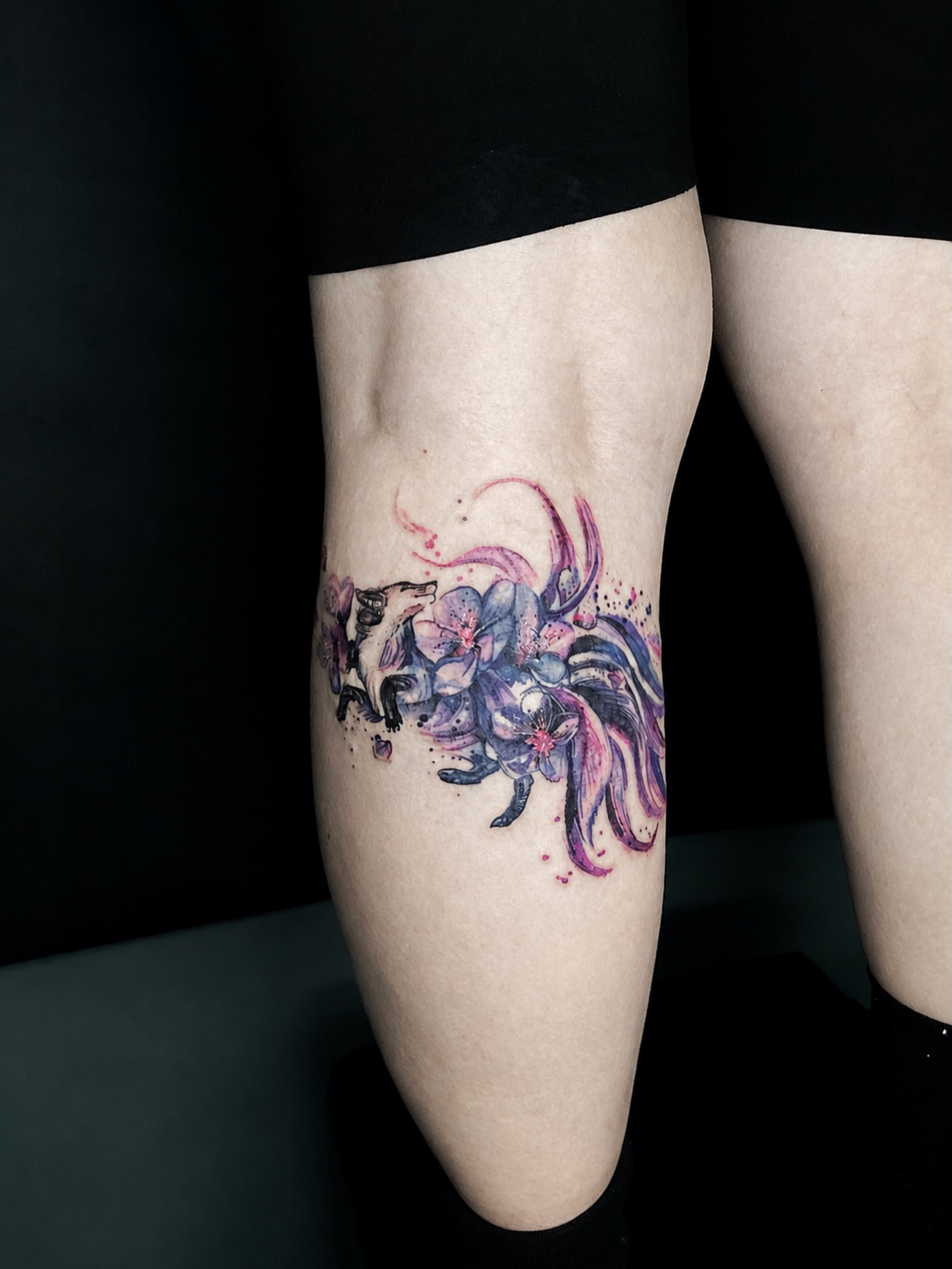 Fox and flowers watercolor tattoo on the thigh by Alexey Molyarenko