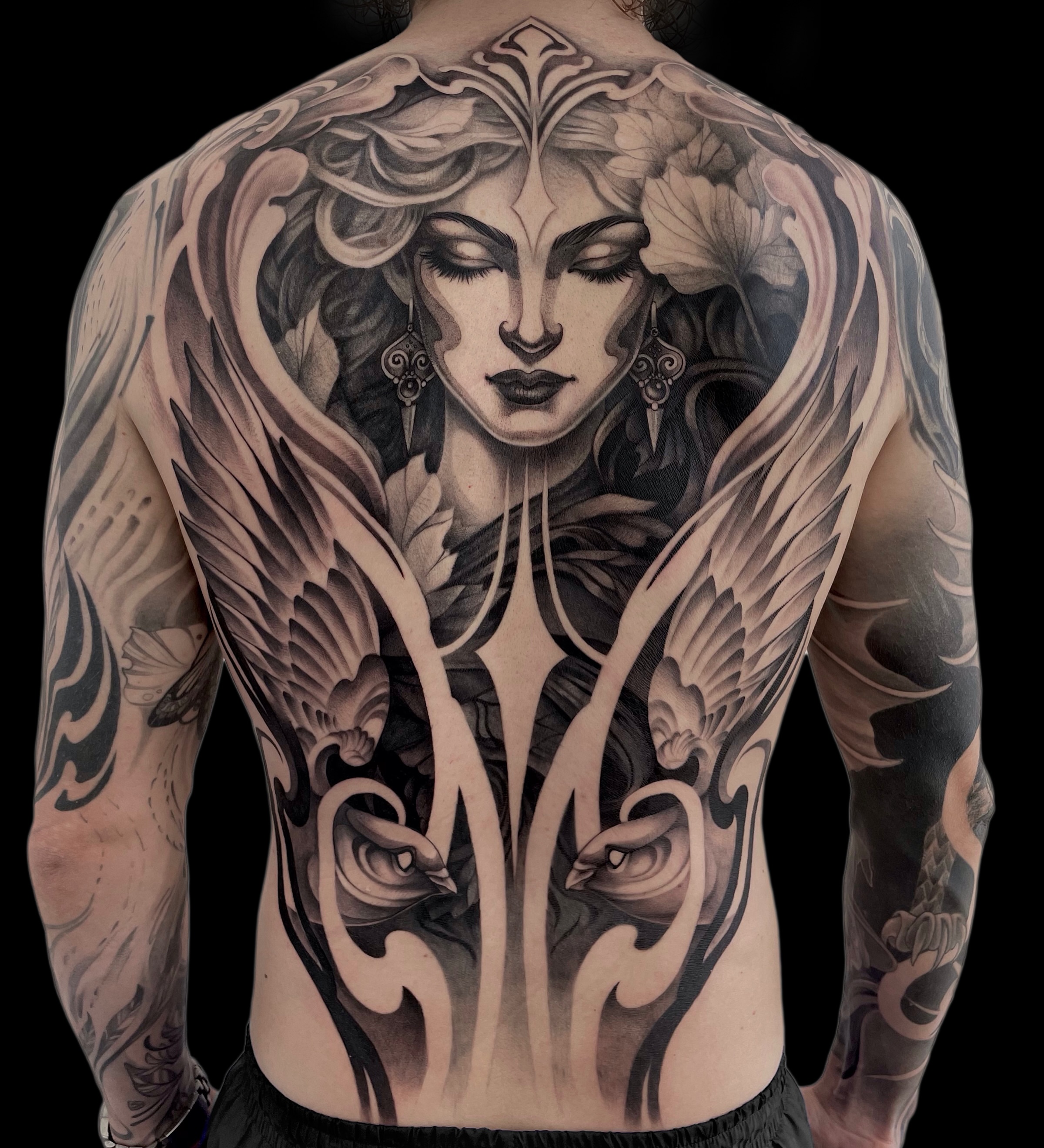 Woman with wings realism tattoo on the back by Michelle Carlton