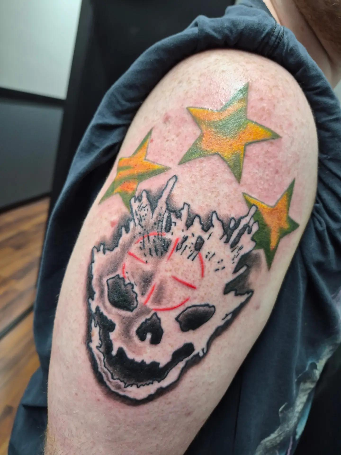 Skull with stars black and grey tattoo on the shoulder by Matt Williamson