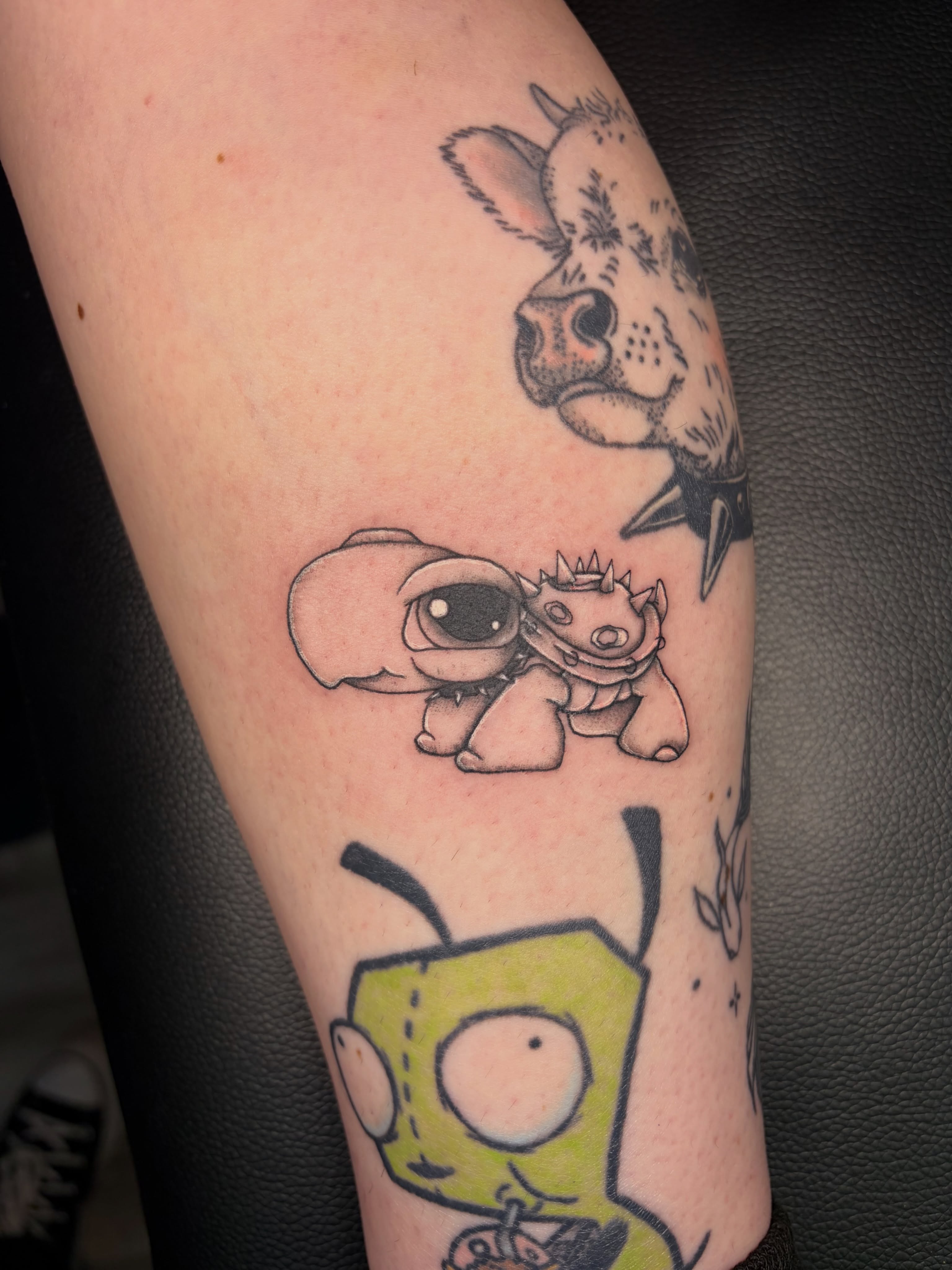 Stitch and friends black and grey tattoo on the forearm by Kiersten Tickle