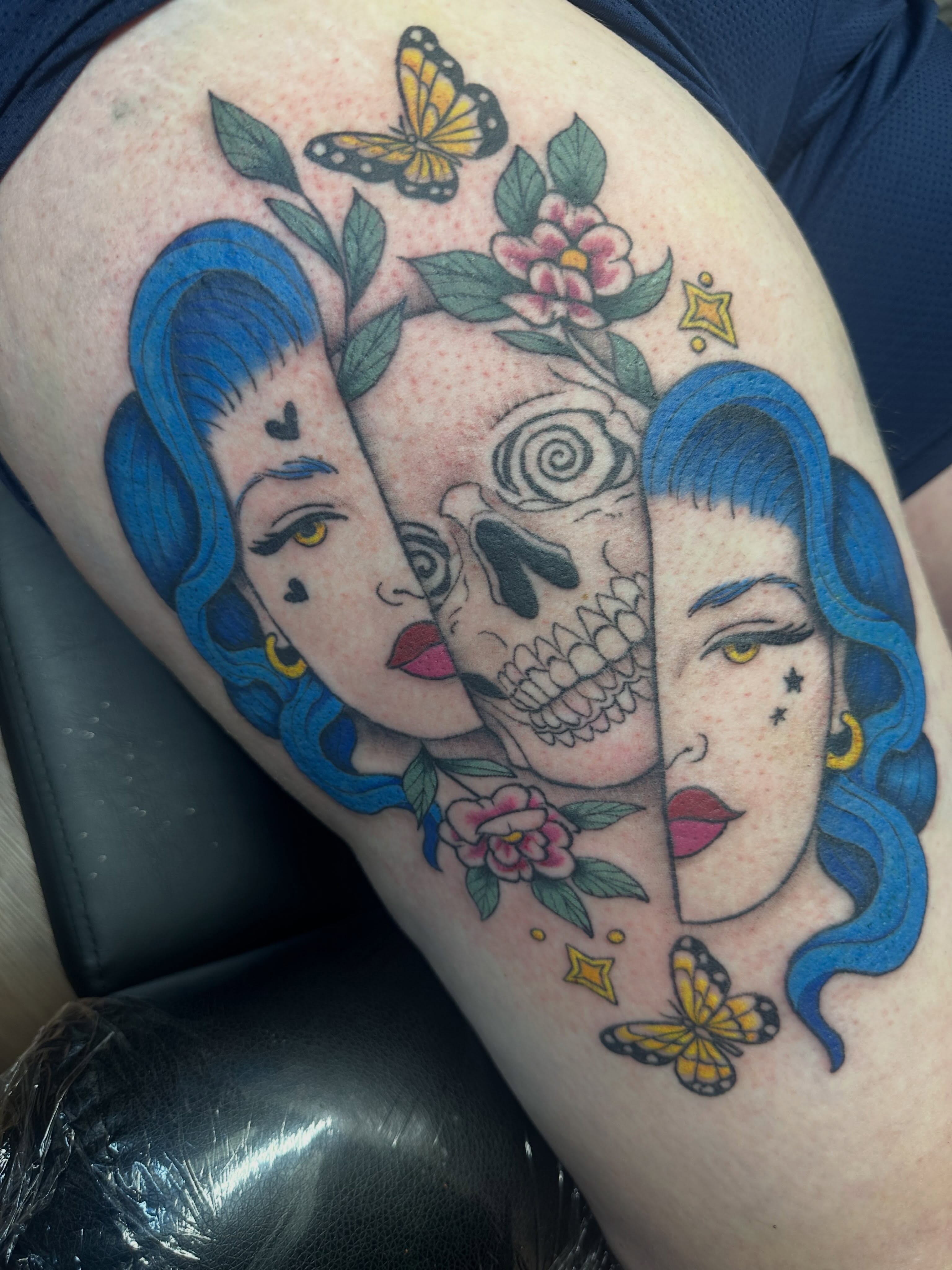 Female faces and skull American traditional tattoo on the thigh by Lindsey Bendsey