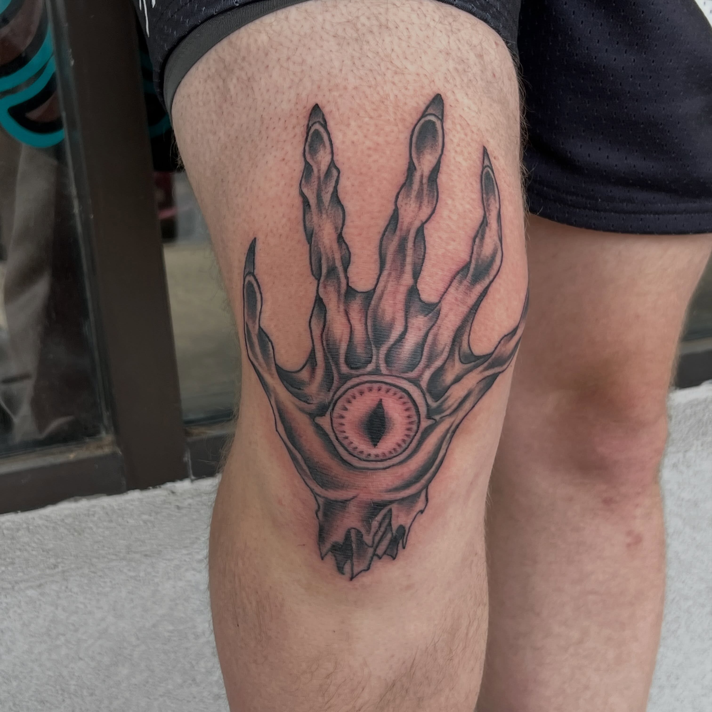 Eye with flame-like fingers dark realism tattoo on the thigh by Callie πͺ