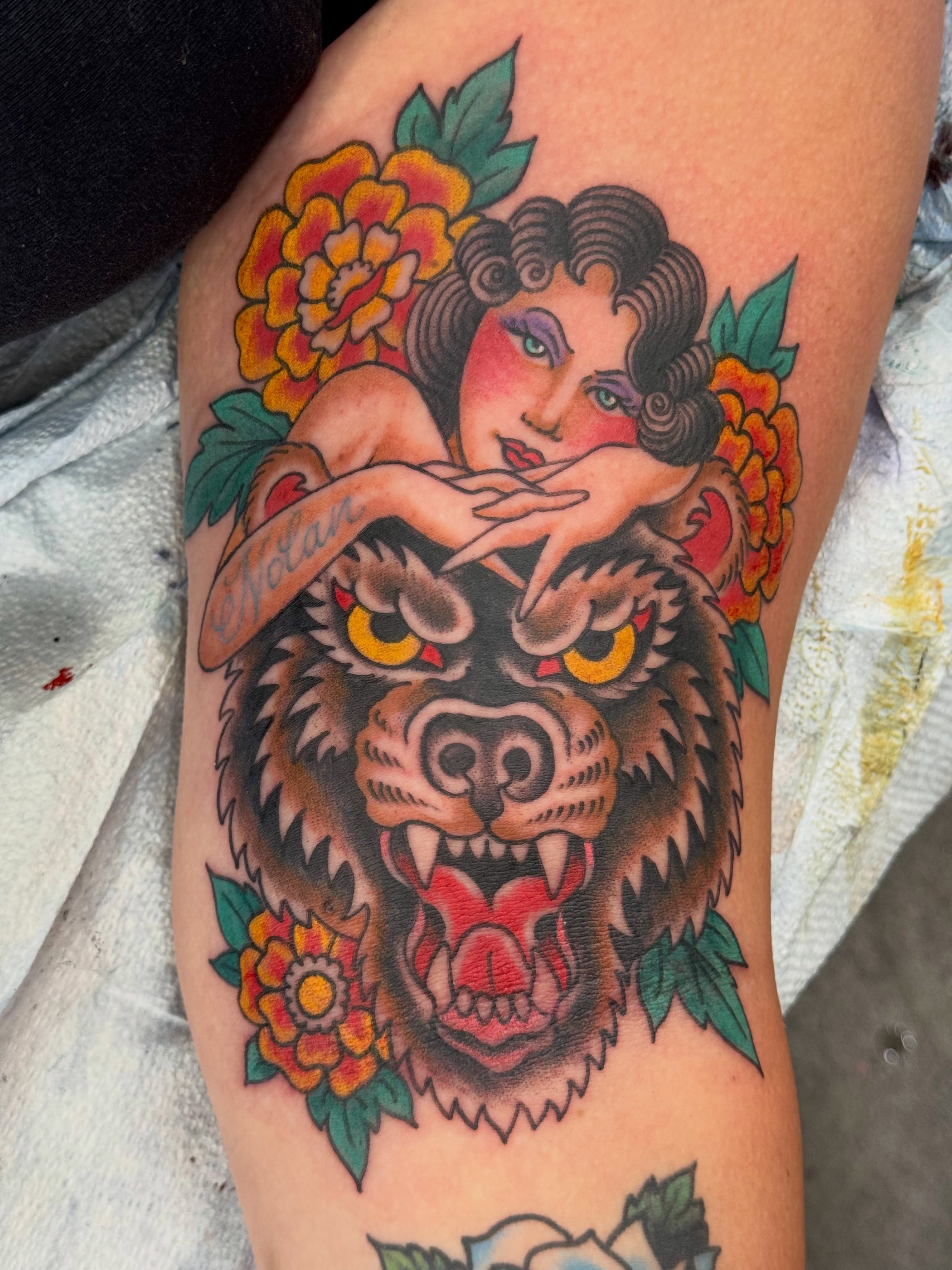 Woman with bear American traditional tattoo on the thigh by Ben Karnofsky