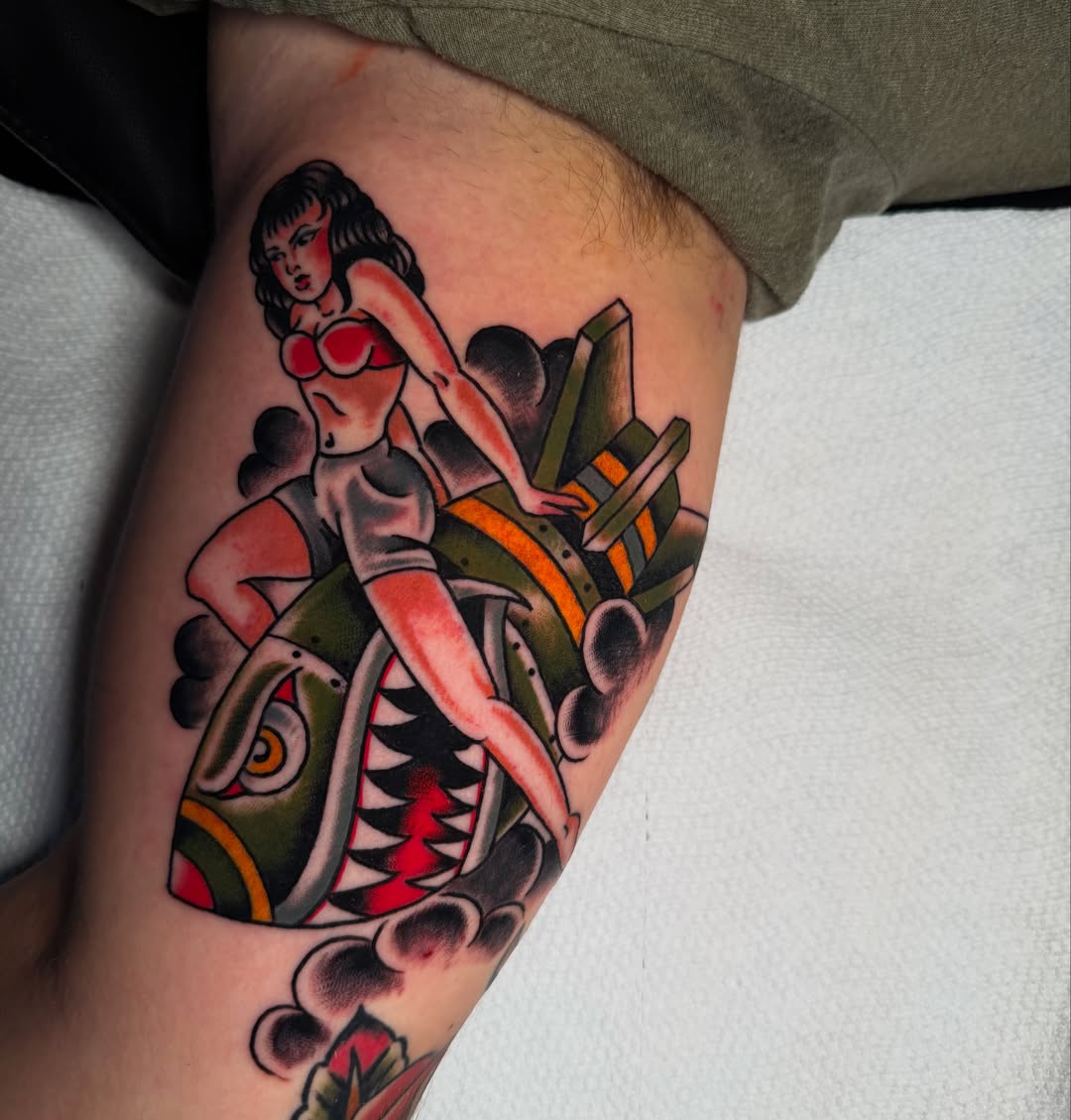 Pin-up girl riding motorcycle American traditional tattoo on the thigh by πππ’π―π’π¨ πππΆπ©π¬π―π, Manchester, New Hampshire