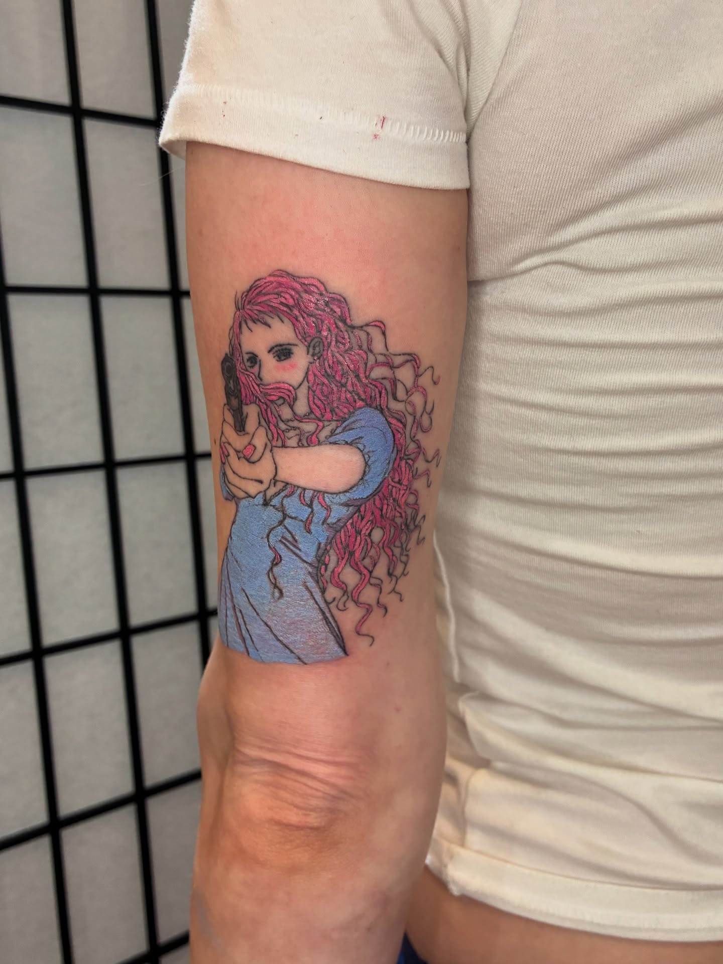 Woman with gun realism tattoo on the forearm by Steph Liebetreu