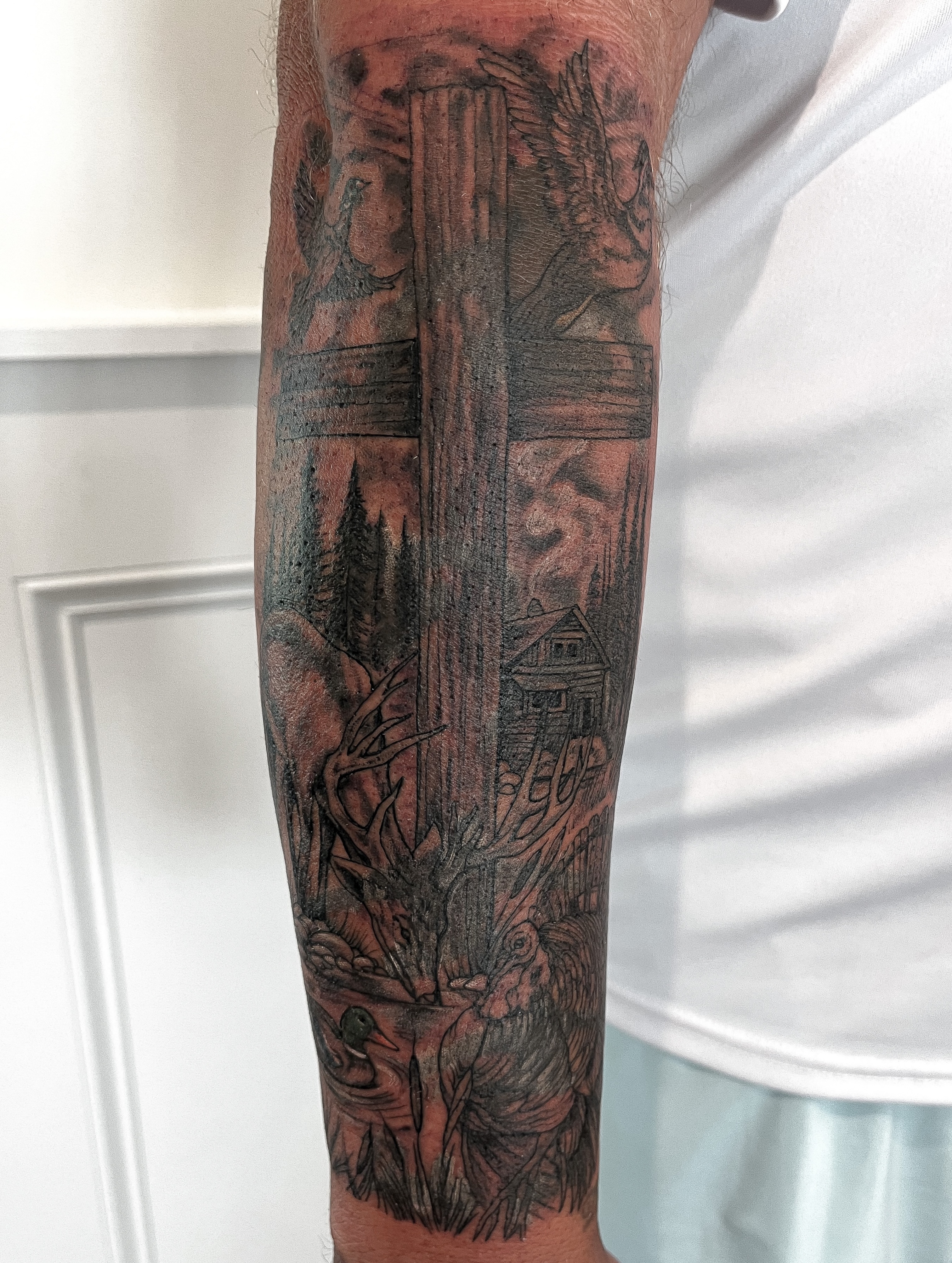 Forest scene realism tattoo on the forearm by Janelle Cuba
