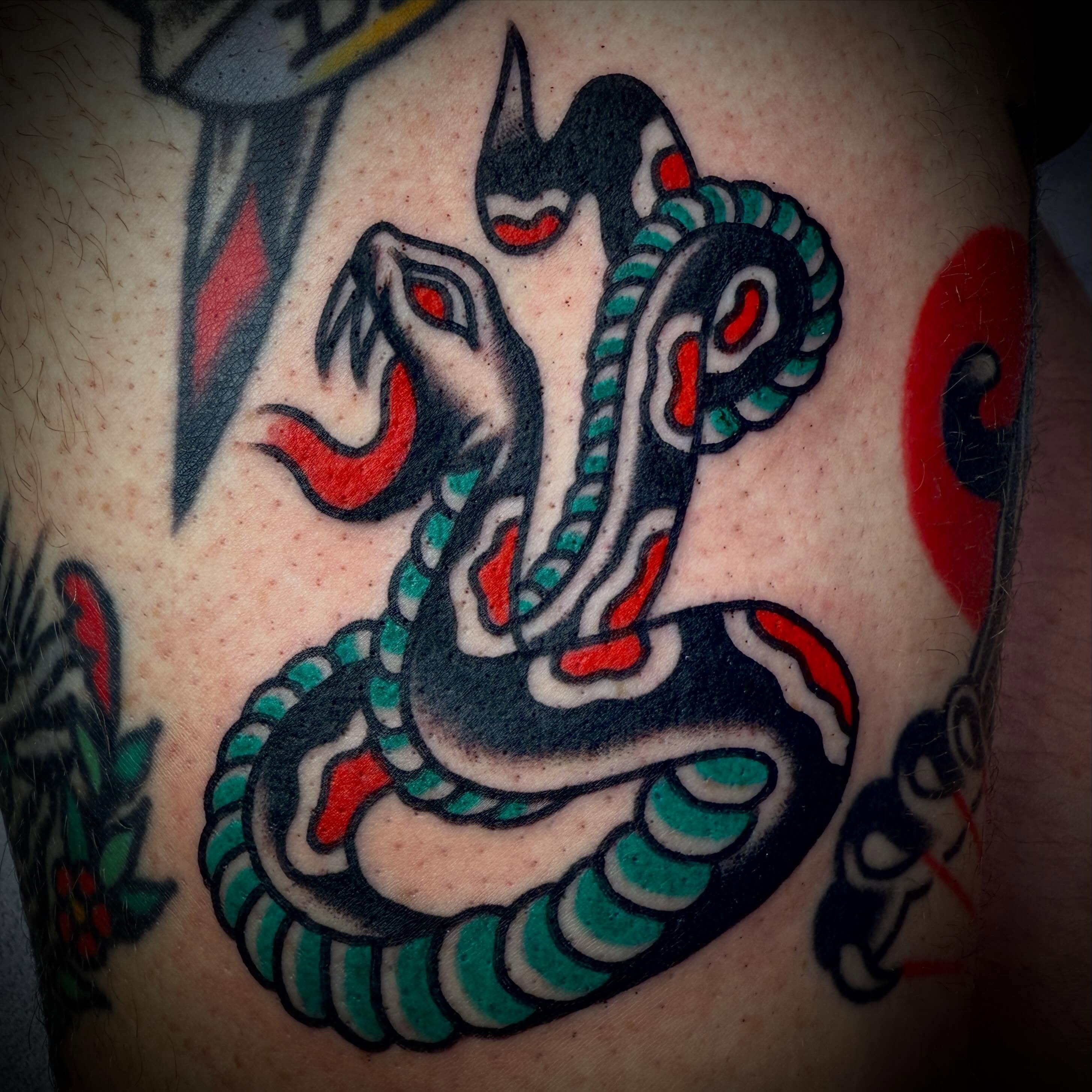 Snake American traditional tattoo on the torso by Tristan Bradshaw