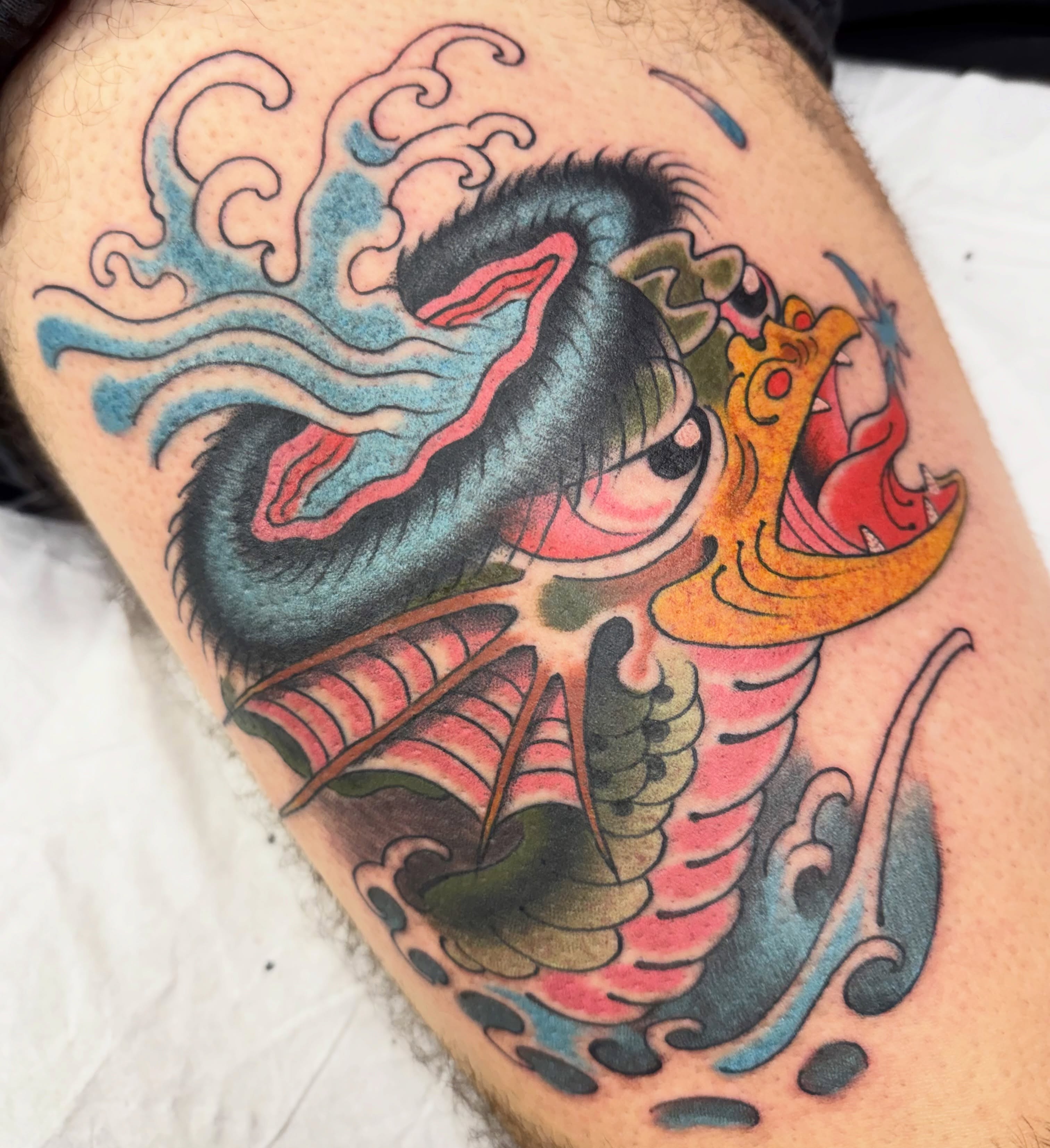 Dragon American traditional tattoo on the thigh by Chris Orta