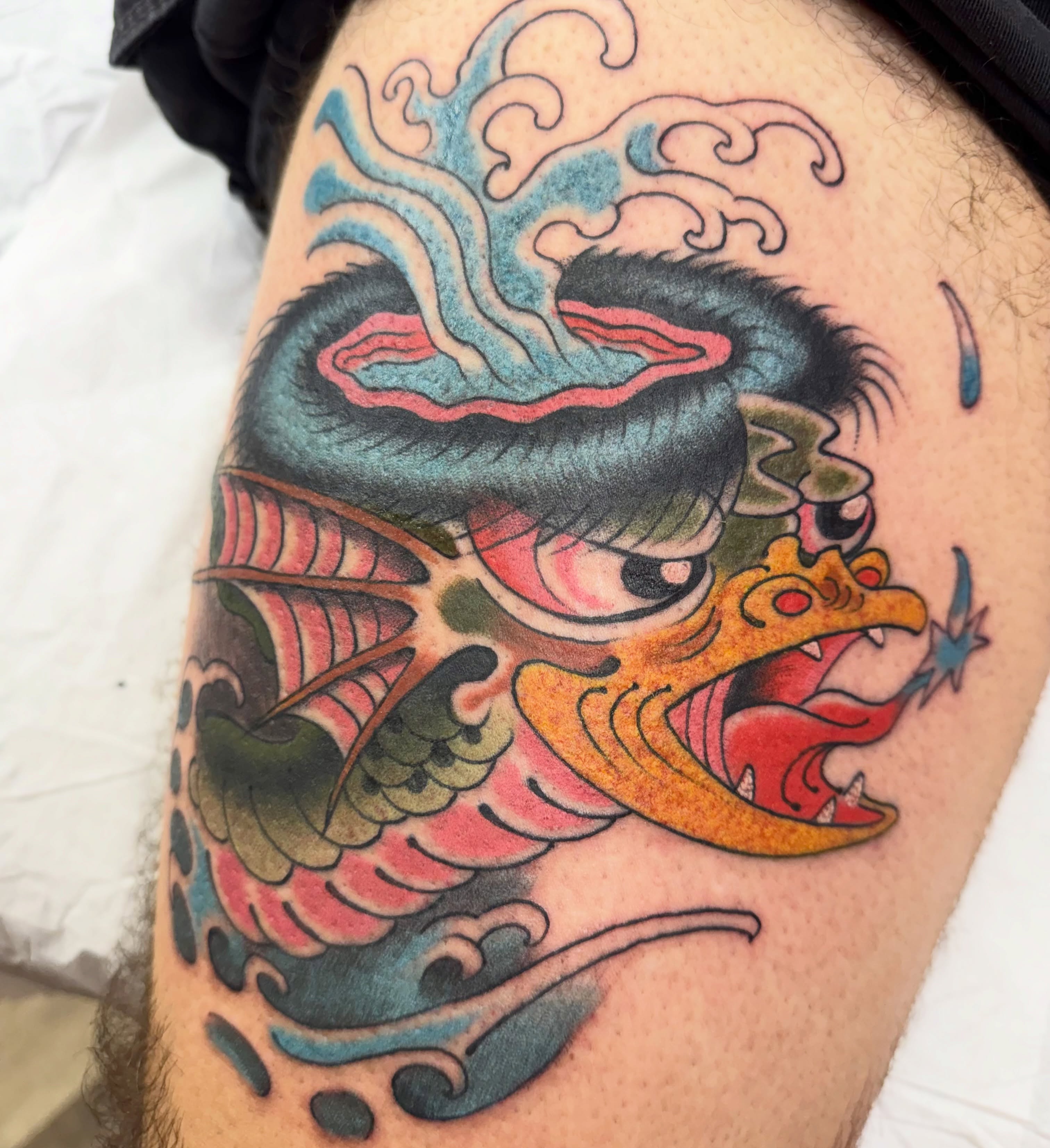 Dragon American traditional tattoo on the thigh by Chris Orta