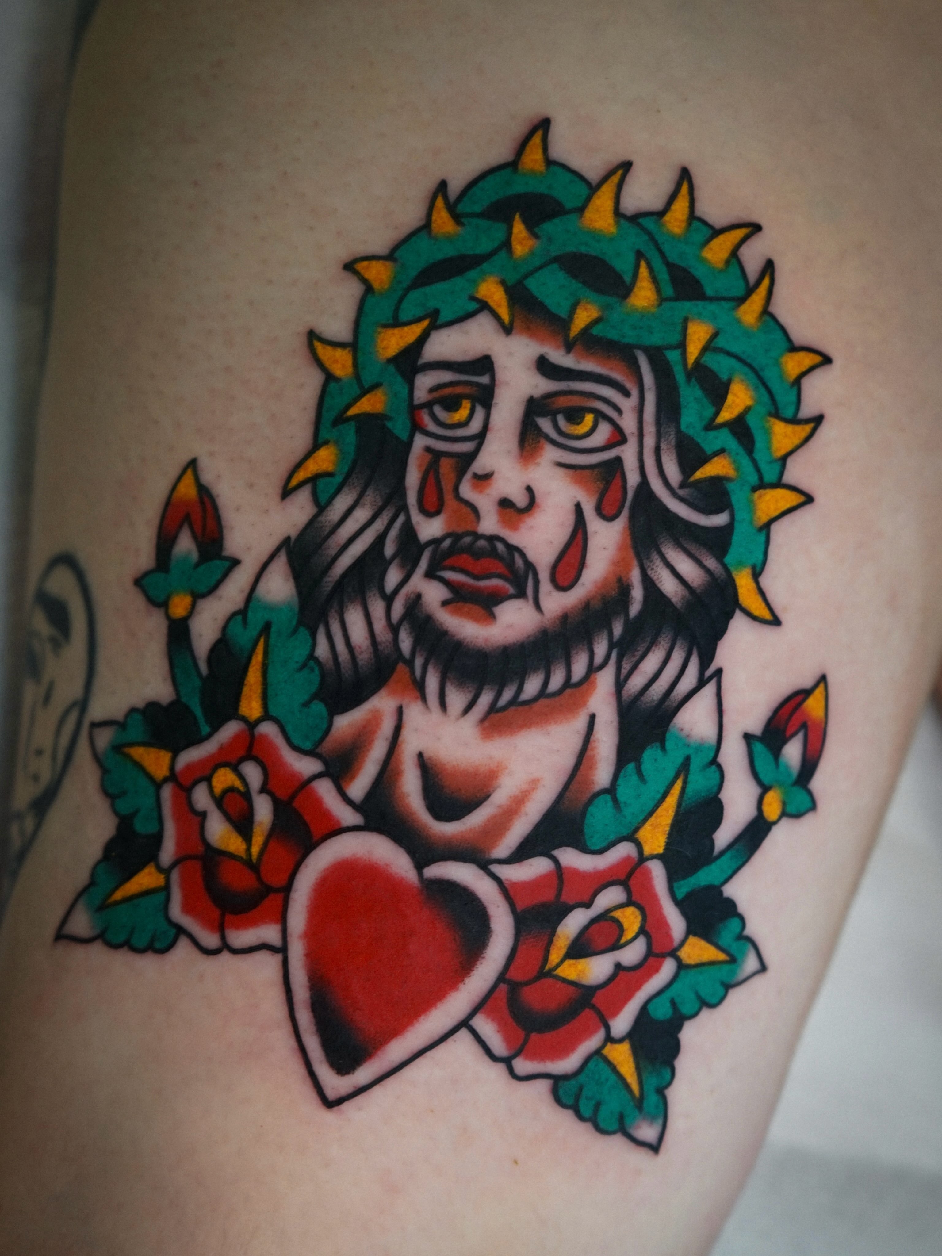 Jesus Christ American traditional tattoo on the thigh by Emily Devenz