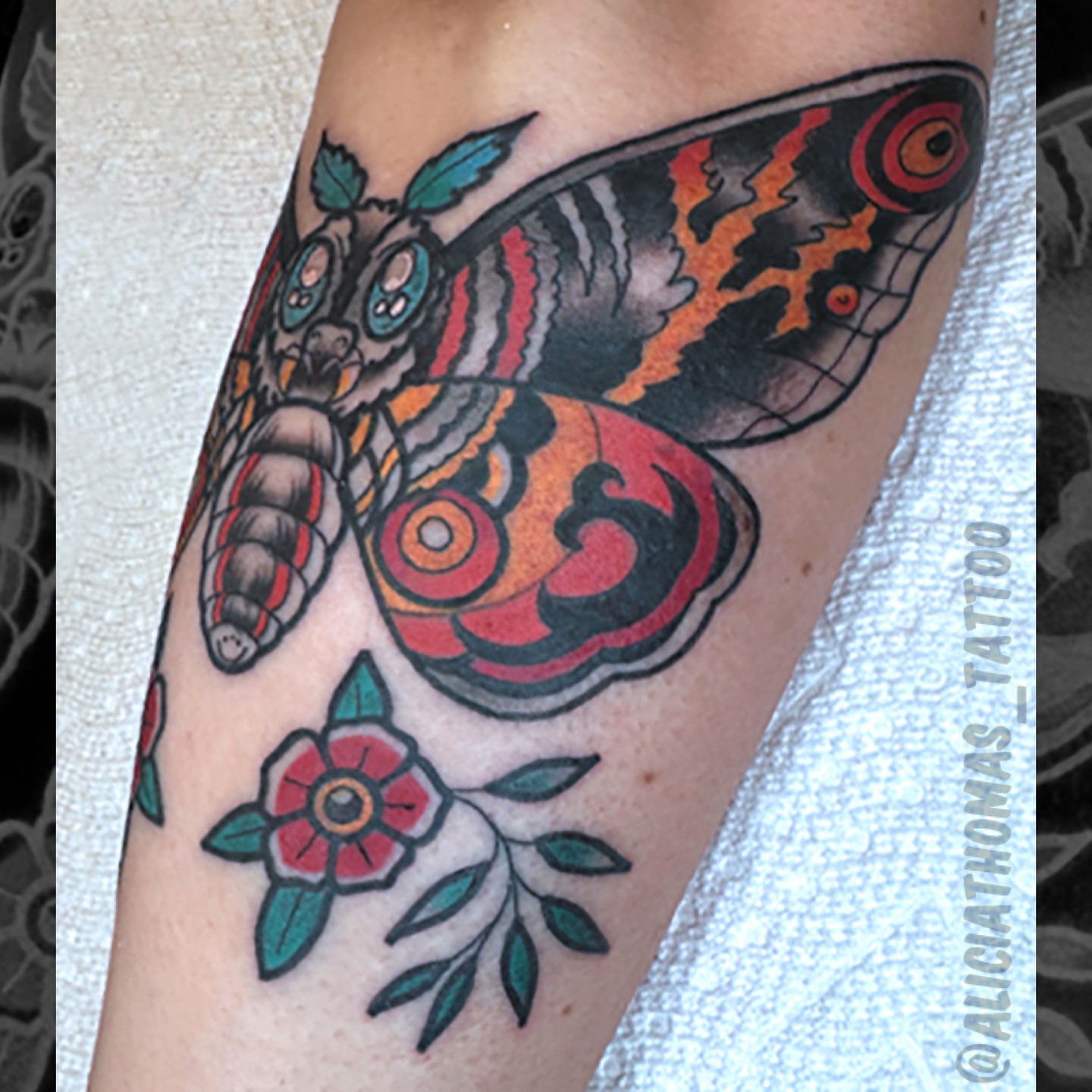 Butterfly and flower American traditional tattoo on the forearm by 𝖆𝖑𝖎𝖈𝖎𝖆 𝖙𝖍𝖔𝖒𝖆𝖘