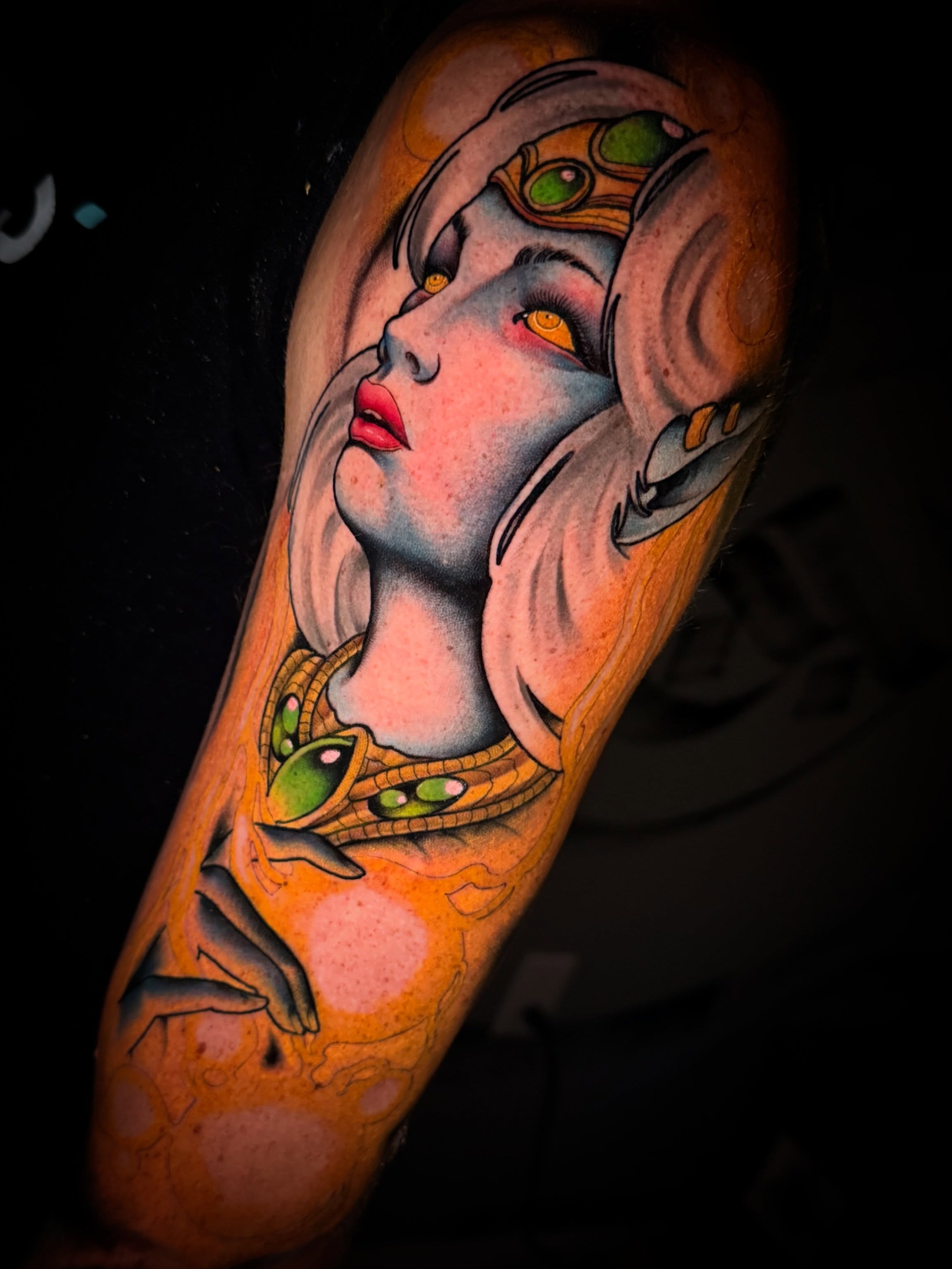 Woman with alien eyes illustrative tattoo on the forearm by Dave Osrowitz