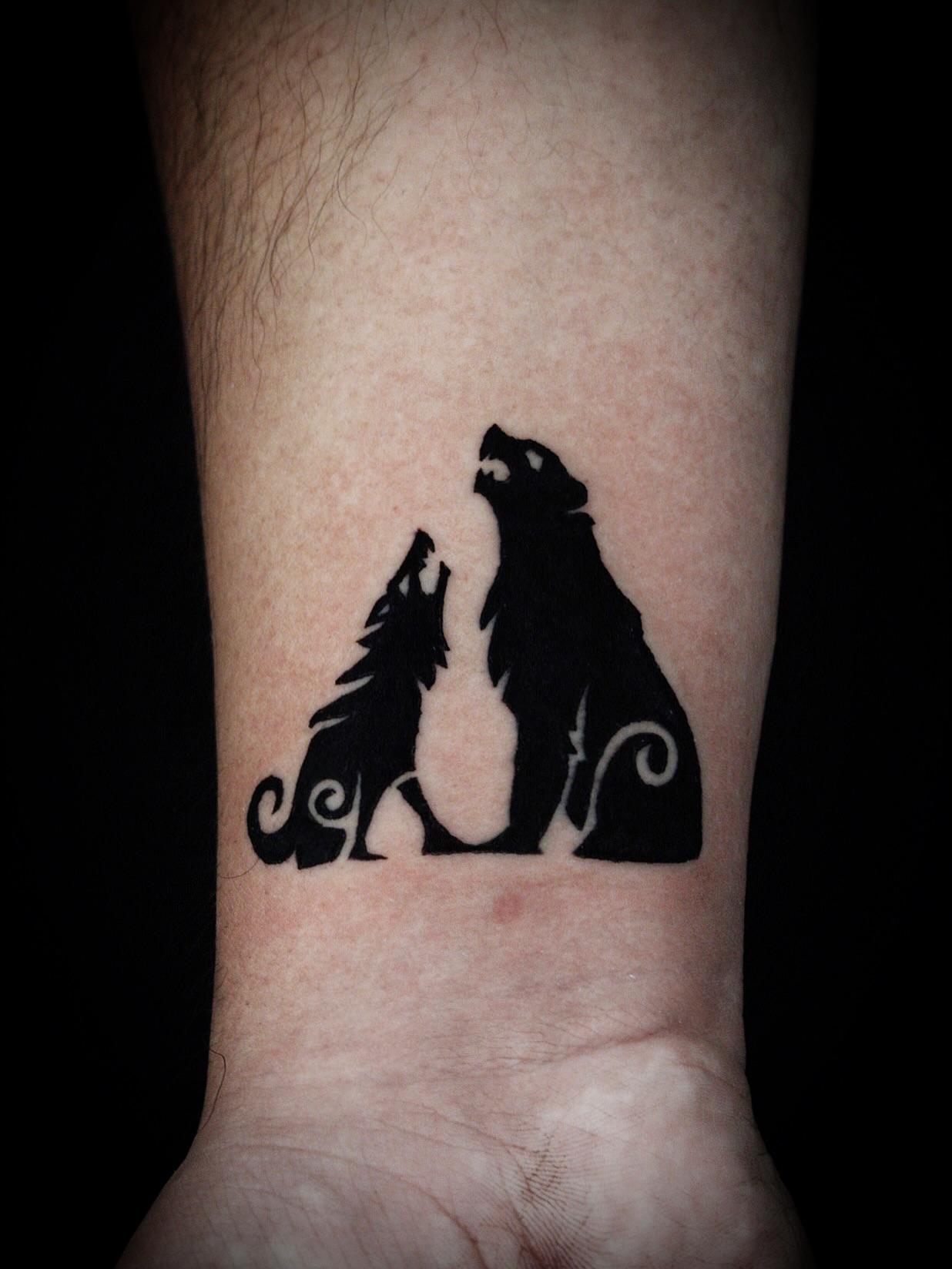 Wolves black and grey tattoo on the forearm by Kanya, Alhambra, California