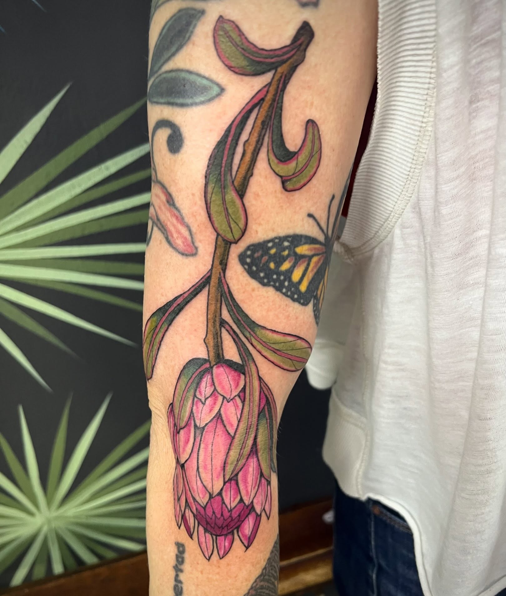 Flower and butterfly American traditional tattoo on the forearm by Natalie Phillips, Oakland, California