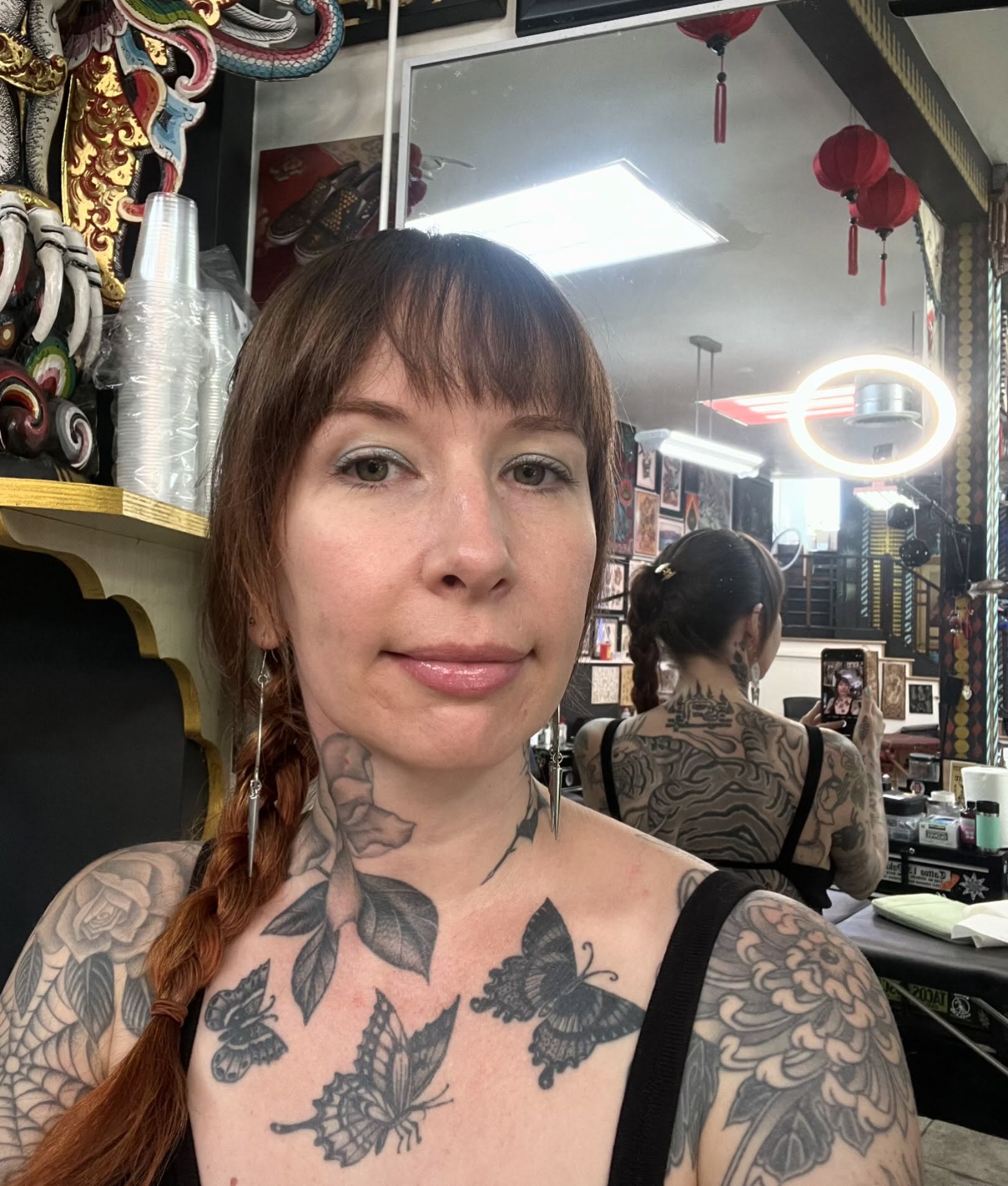 Butterflies and flowers black and grey tattoo on the chest by Natalie Phillips, Oakland, California