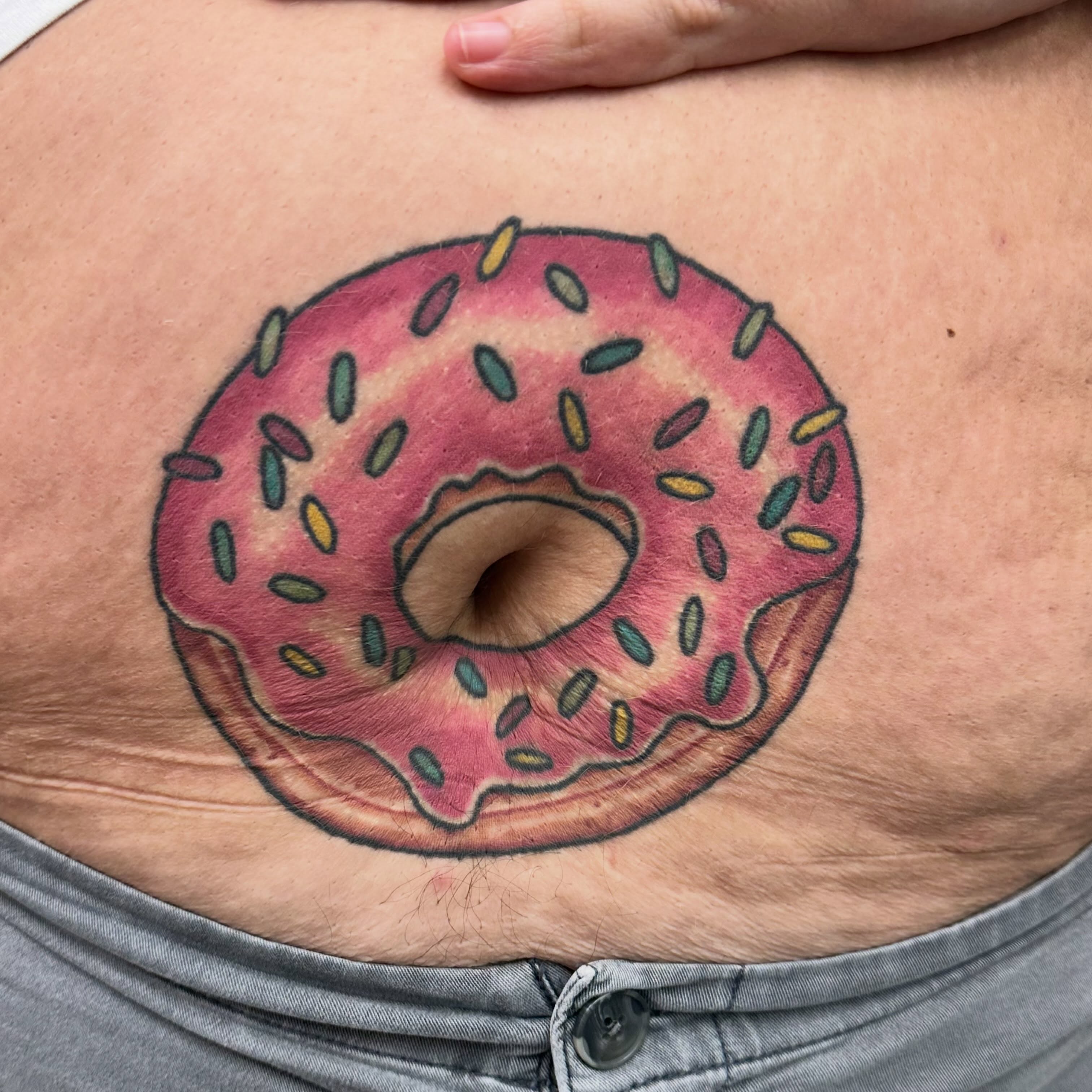 Donut new school tattoo on the torso by Nicki Hoverson