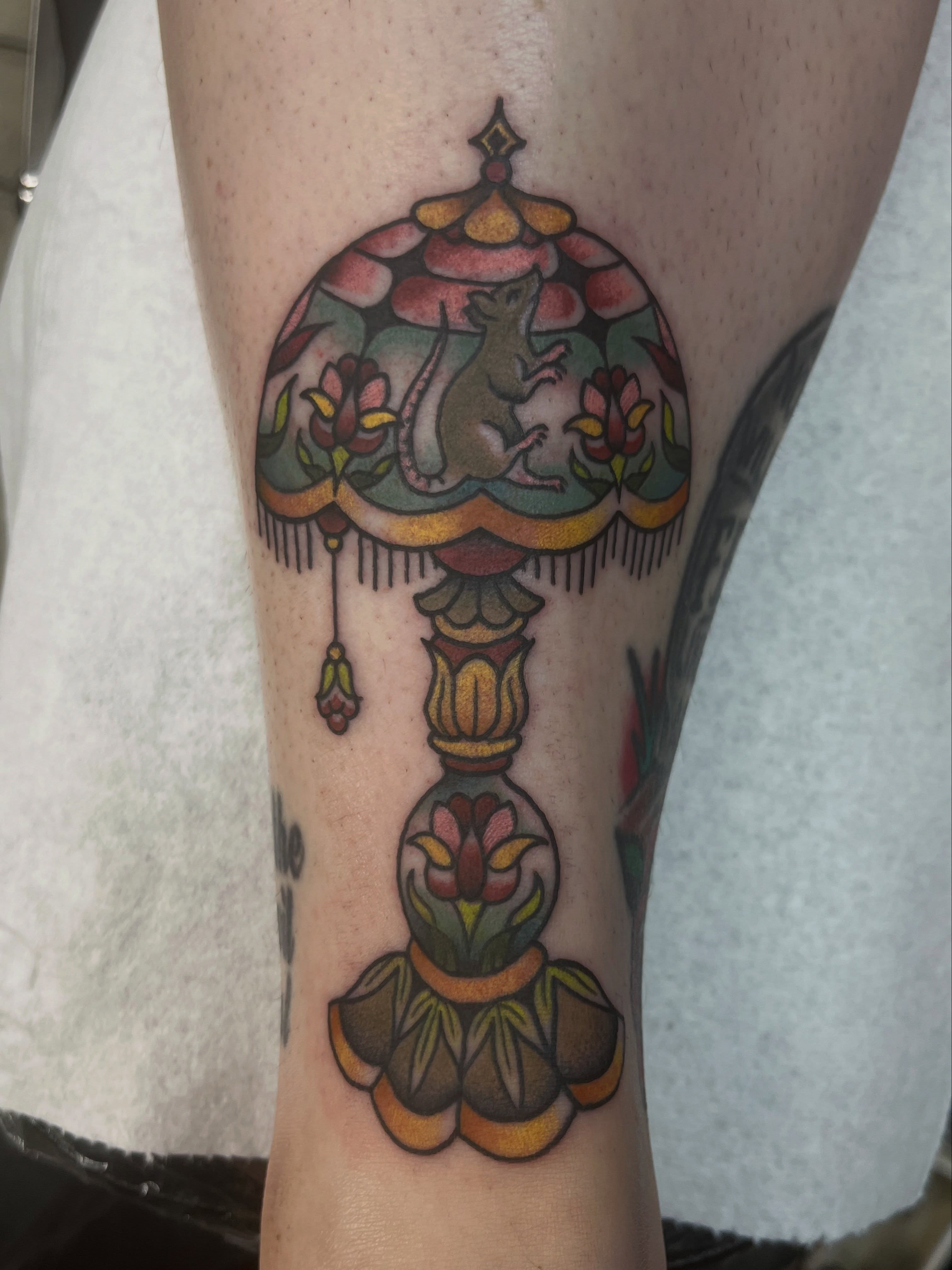 Lampshade with rat American traditional tattoo on the forearm by jay