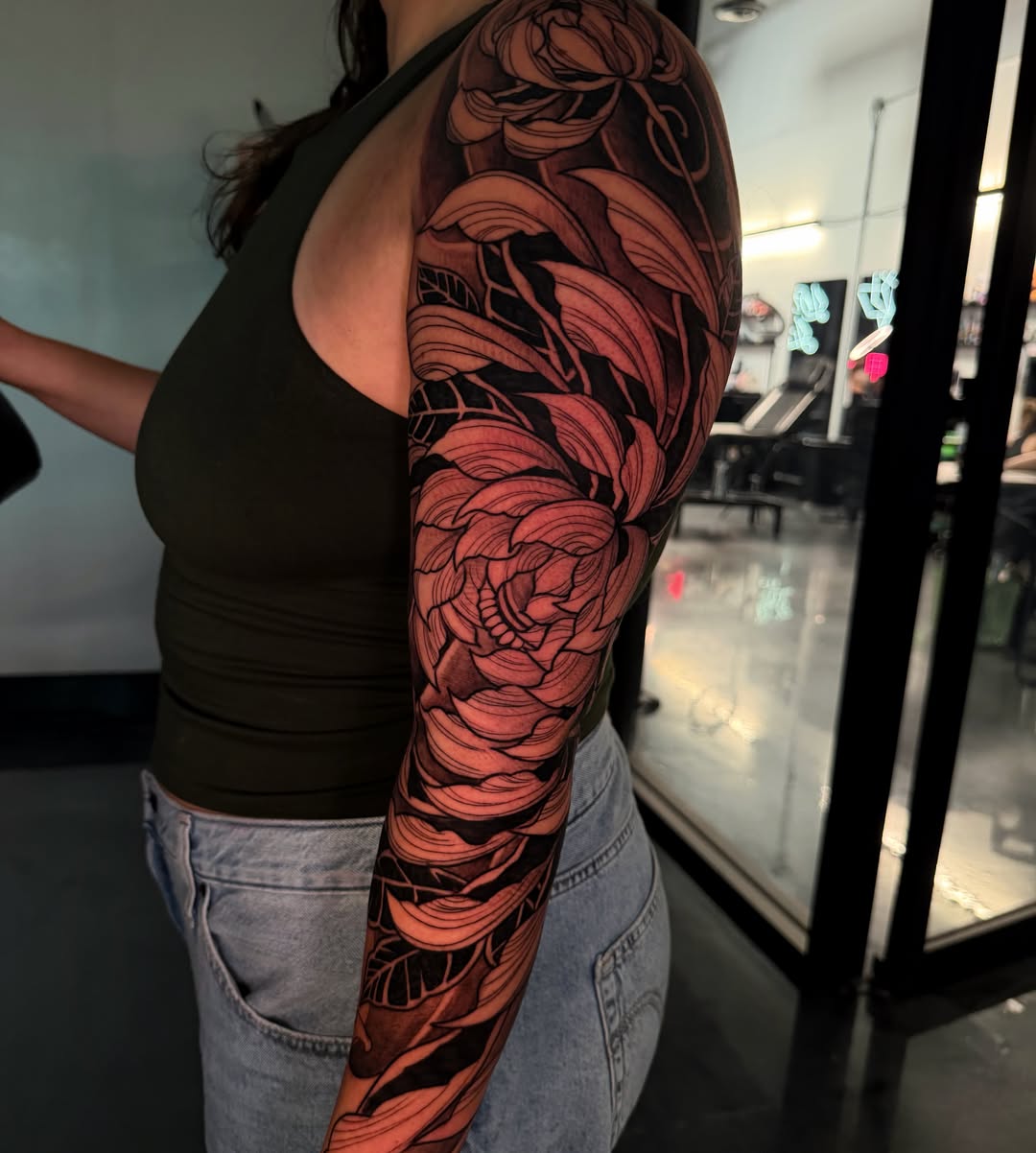 Floral sleeve geometric tattoo on the upper arm by Melissa "Lotuss" Chan