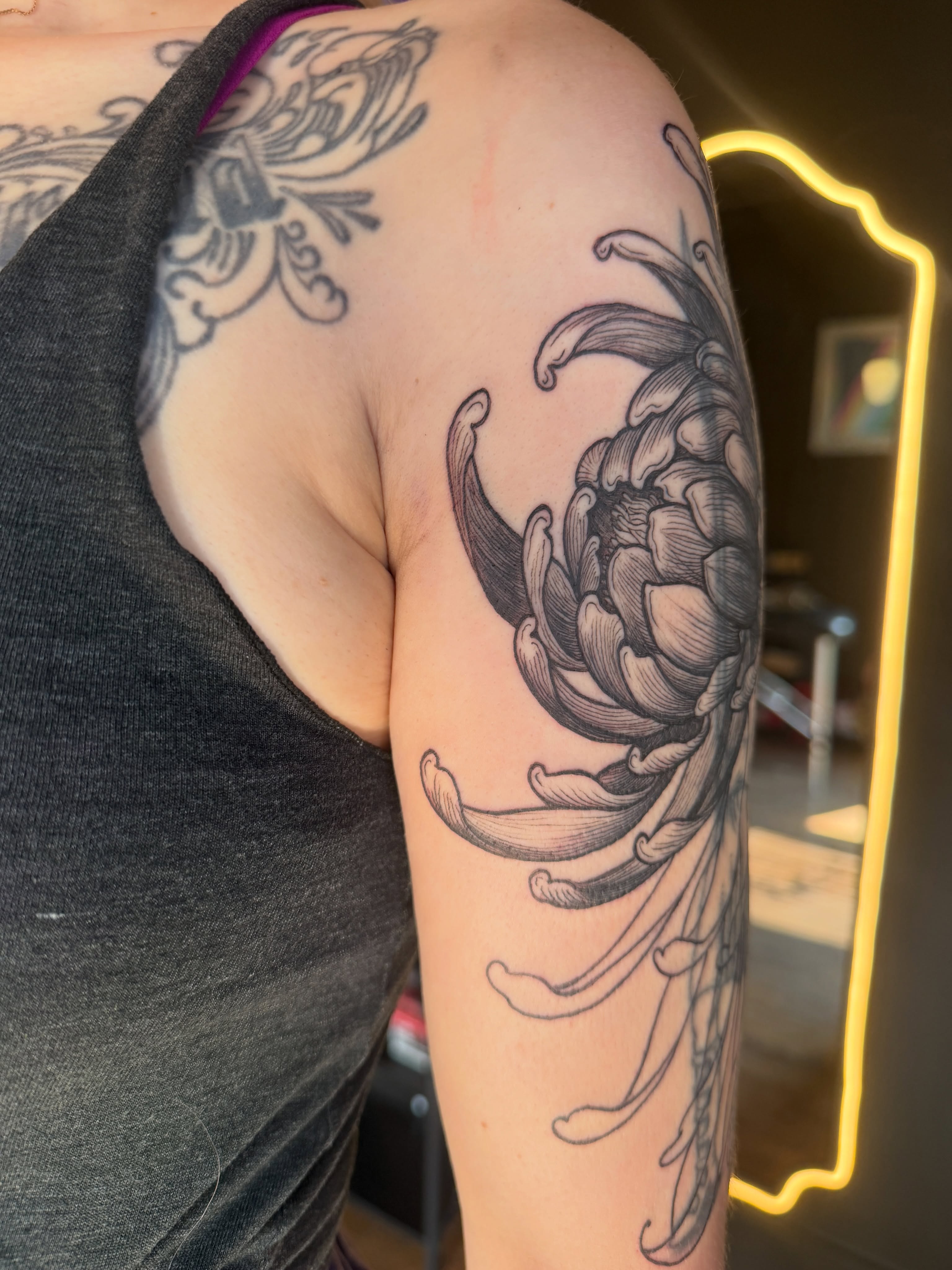 Chrysanthemum black and grey tattoo on the shoulder by Lora Bird