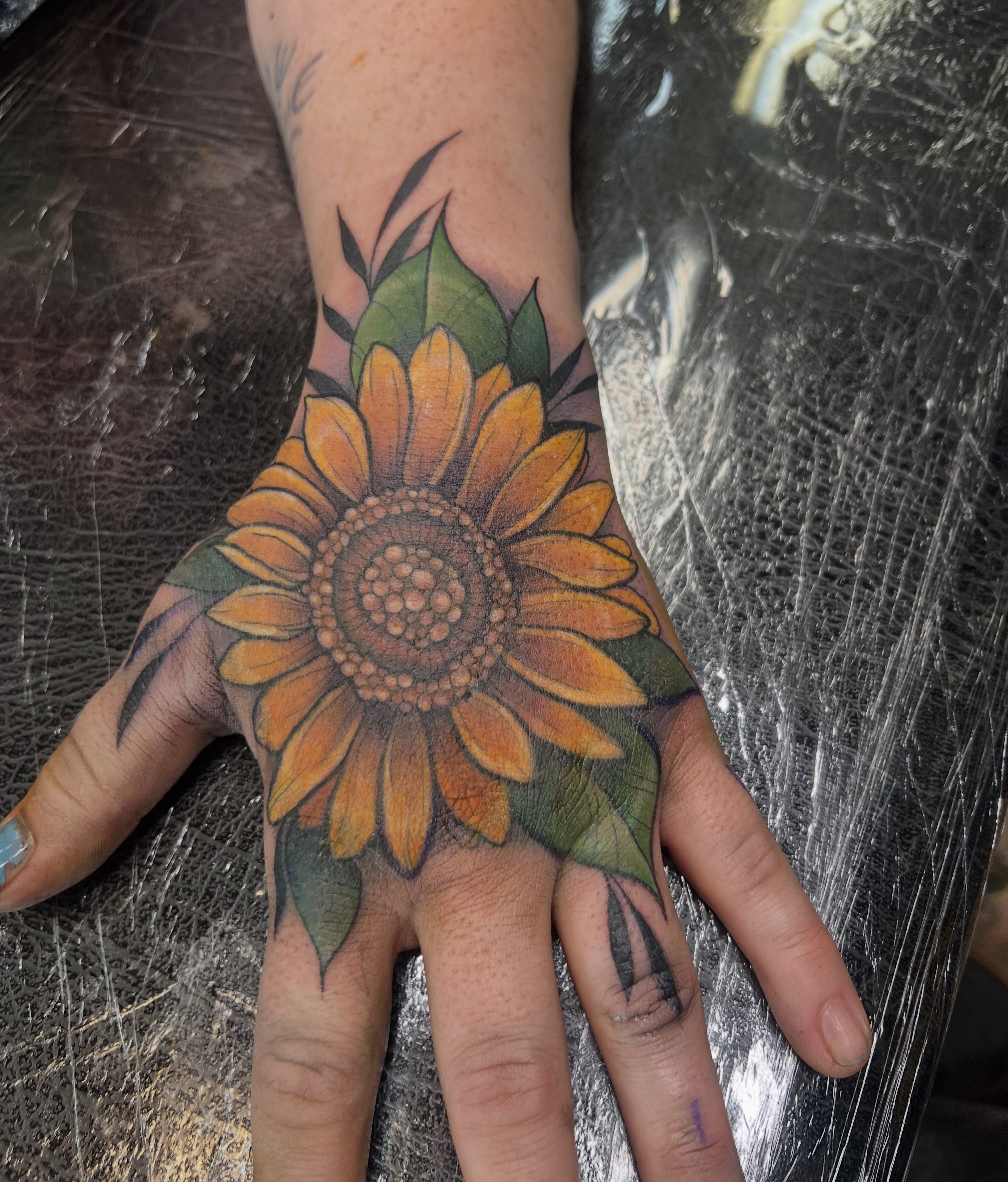 Sunflower realism tattoo on the hand by Bailey Goodwin, Ankeny, Iowa