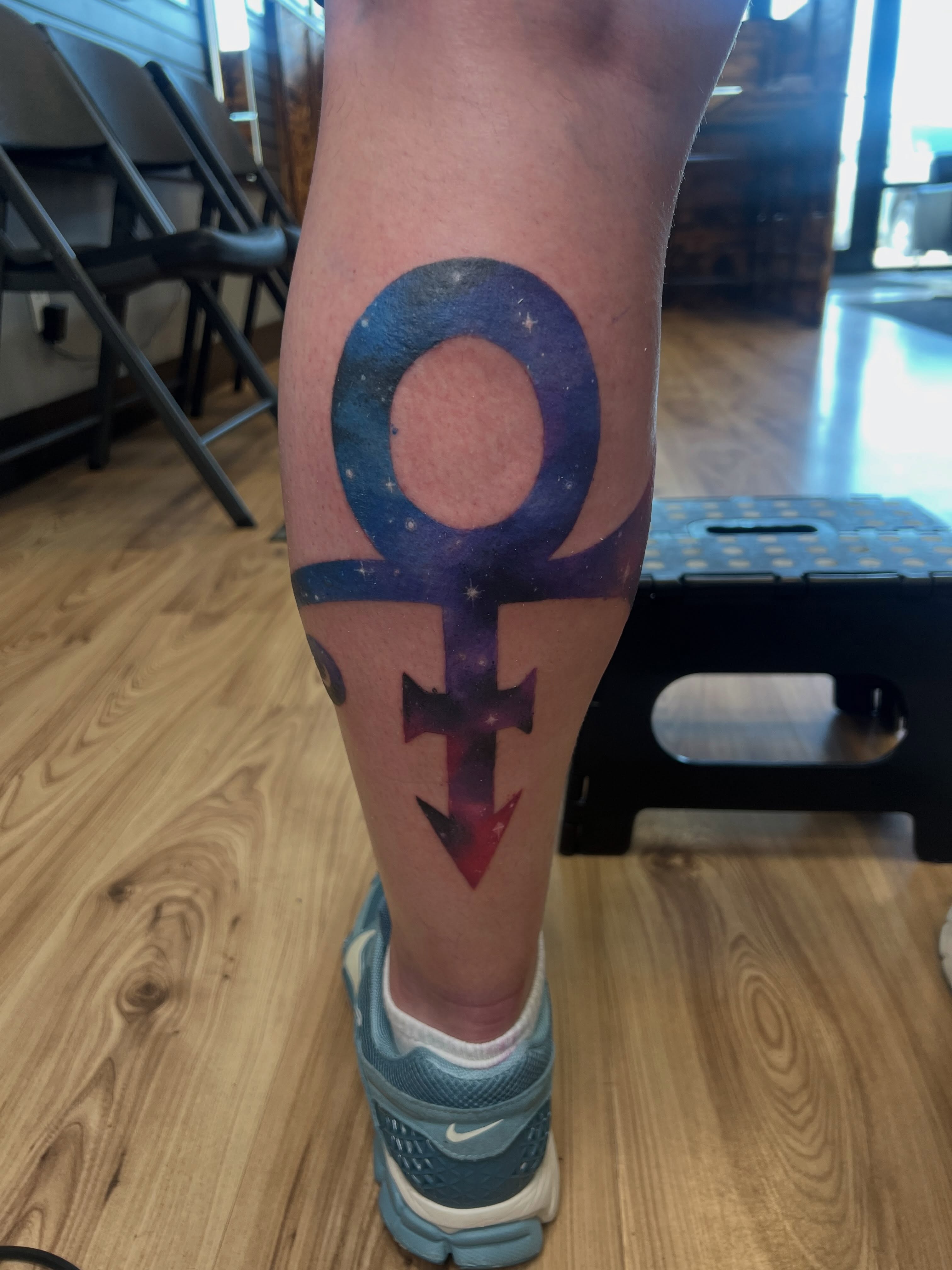 Female symbol geometric tattoo on the calf by Bailey Goodwin, Ankeny, Iowa